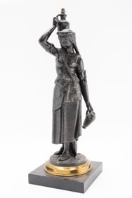 AN ELECTRIFIED BRASS LAMP BASE SCULPTURE OF A WOMAN HOLDING A BASKET.