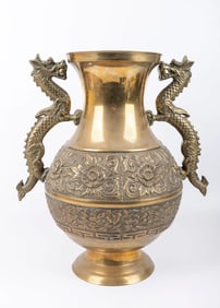 A LARGE BRASS VASE. Probably China, 20th century. Decorated with multiple dragons. 16.5” tall
