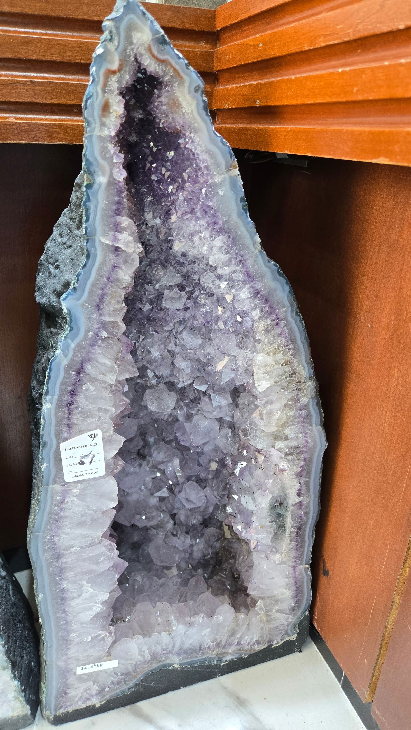 A LARGE AMETHYST CATHEDRAL POLISHED EDGES: Deep purple in color. With a nice soft blue polished rim. 34 kilograms and 24" tall.