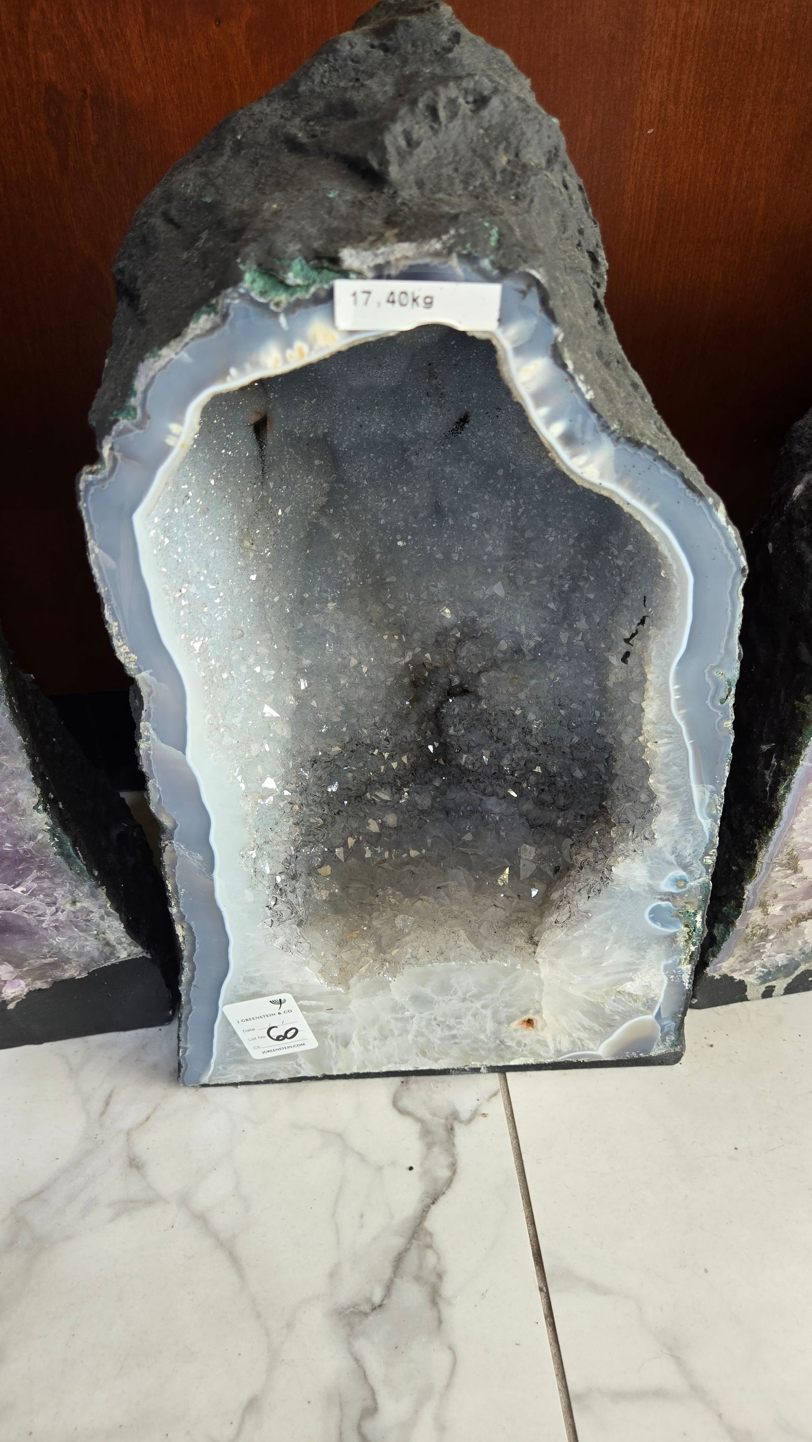 A LARGE AMETHYST GEODE POLISHED EDGES: 17.4 KILOGRAMS AND 16" TALL. light blue in color. deep cavelike