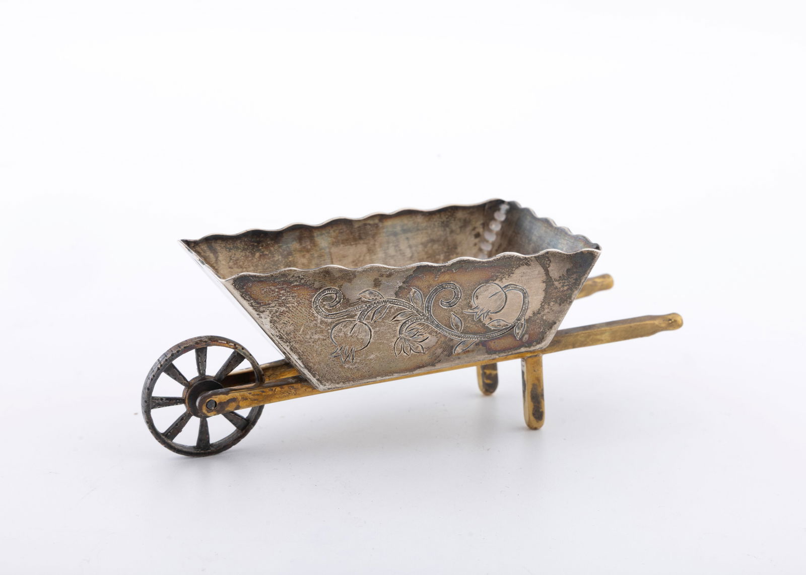 A STERLING SILVER CHAROSET CONTAINER BY SHUKI FREIMAN, JERUSALEM: In the shape of a wheelbarrow. Marked SF and 925. 3.43 ozt and 4.8" long.