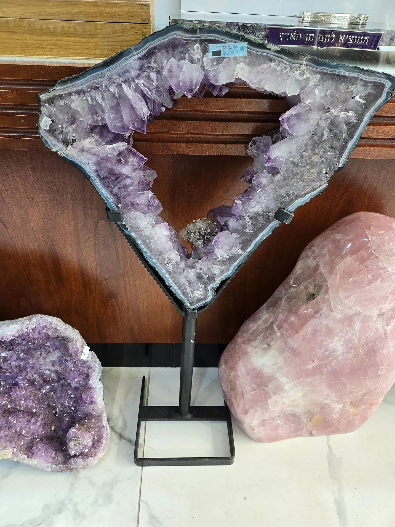 A LARGE AND WELL COLORED AMETHYST TRIANGLE SLICE ON A STAND: Here is a magnificent amethyst specimen crossection on a stand