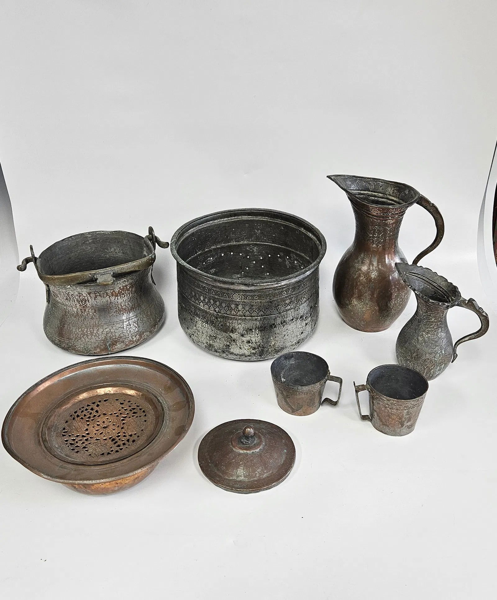 A COLLECTION OF FIVE HAND WROUGHT BOWLS, PITCHERS AND AN INCENSE BURNER: Most Likely Persian, c. 1920. Including bowls and planters. The large bowl is 11" wide and the large pitcher is 11.7" tall.