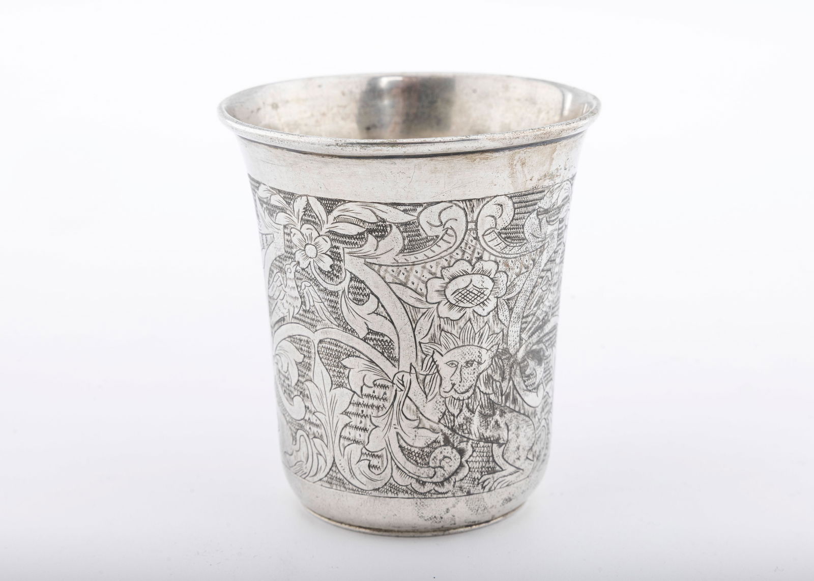 A SILVER KIDDUSH CUP. Ukraine, c. 1820: Beaker form. Engraved with floral designs, multiple lions Ukranian sunflowers and scrolling work. Marked 12. 2.7" tall and 73.9 grams