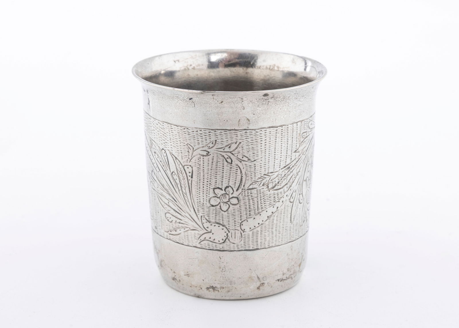 A SILVER KIDDUSH CUP. Ukraine, c. 1820: Beaker form. Engraved with floral designs, and scrolling work. Marked 12 and maker JS. 2.3" tall and 75.6 grams