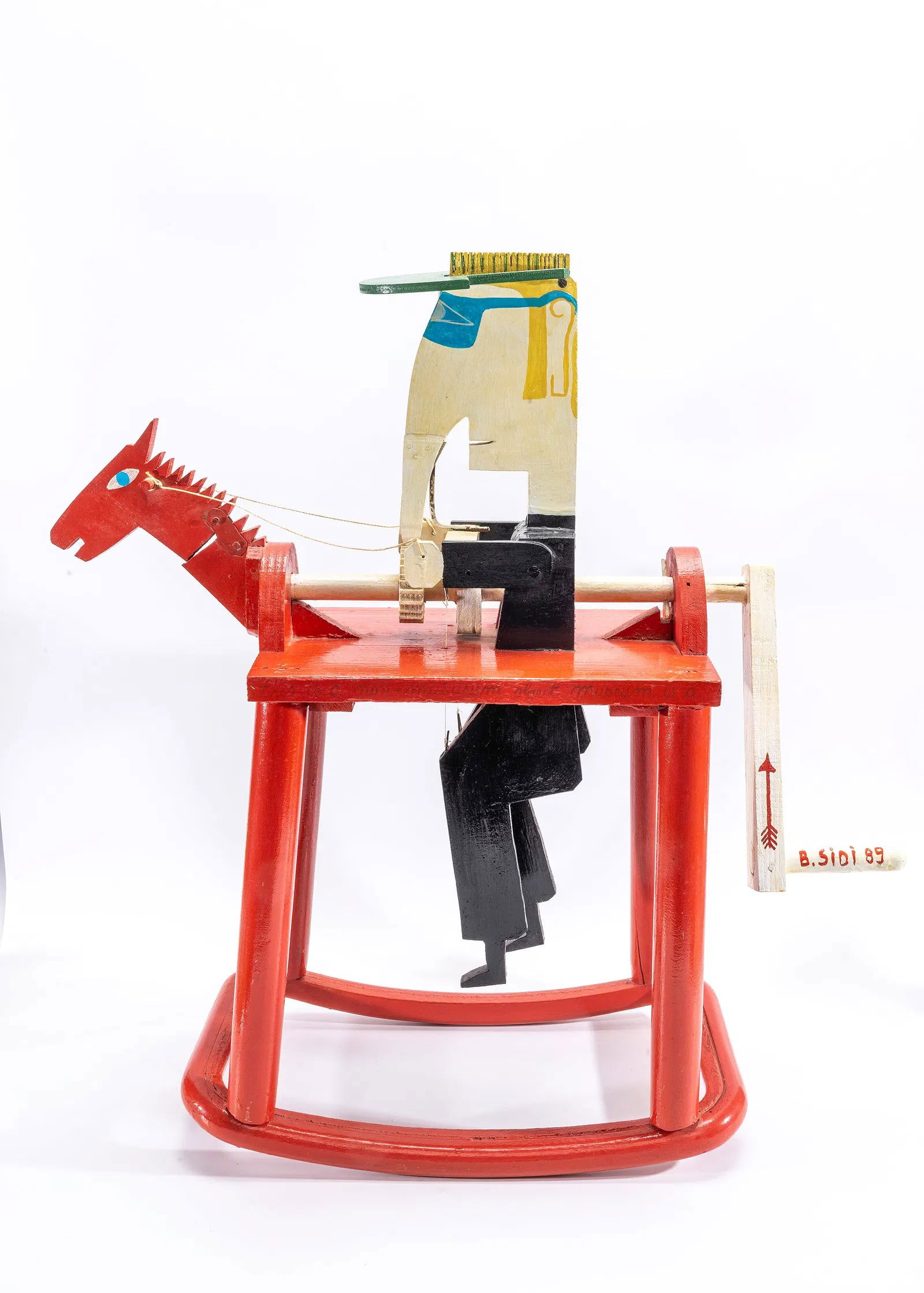 ELIYAHU SIDI - RED HORSE GRAGGER: Bernard Eliyahu Sidi (B. 1936, France). Rotating gragger. Man sitting on a red horse. 25" tall