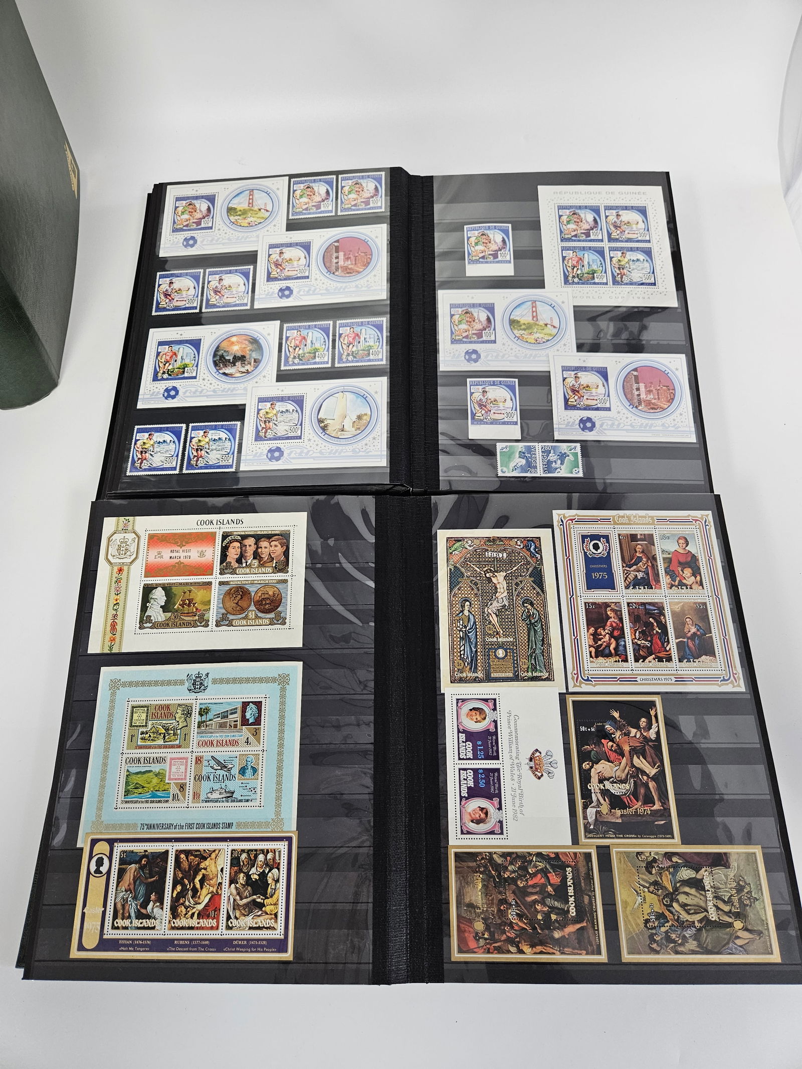 A MASSIVE COLLECTION OF COMMEMORATIVE STAMPS HOUSED IN 5 ALBUMS: Including mint stamps from the Cook Islands, Grenada, World Cup stamps, United Kingdom, Mongolia, Dominica, Gambia, Liberia, United States, Tonga, Australia. Hundreds and Hundreds of stamps.