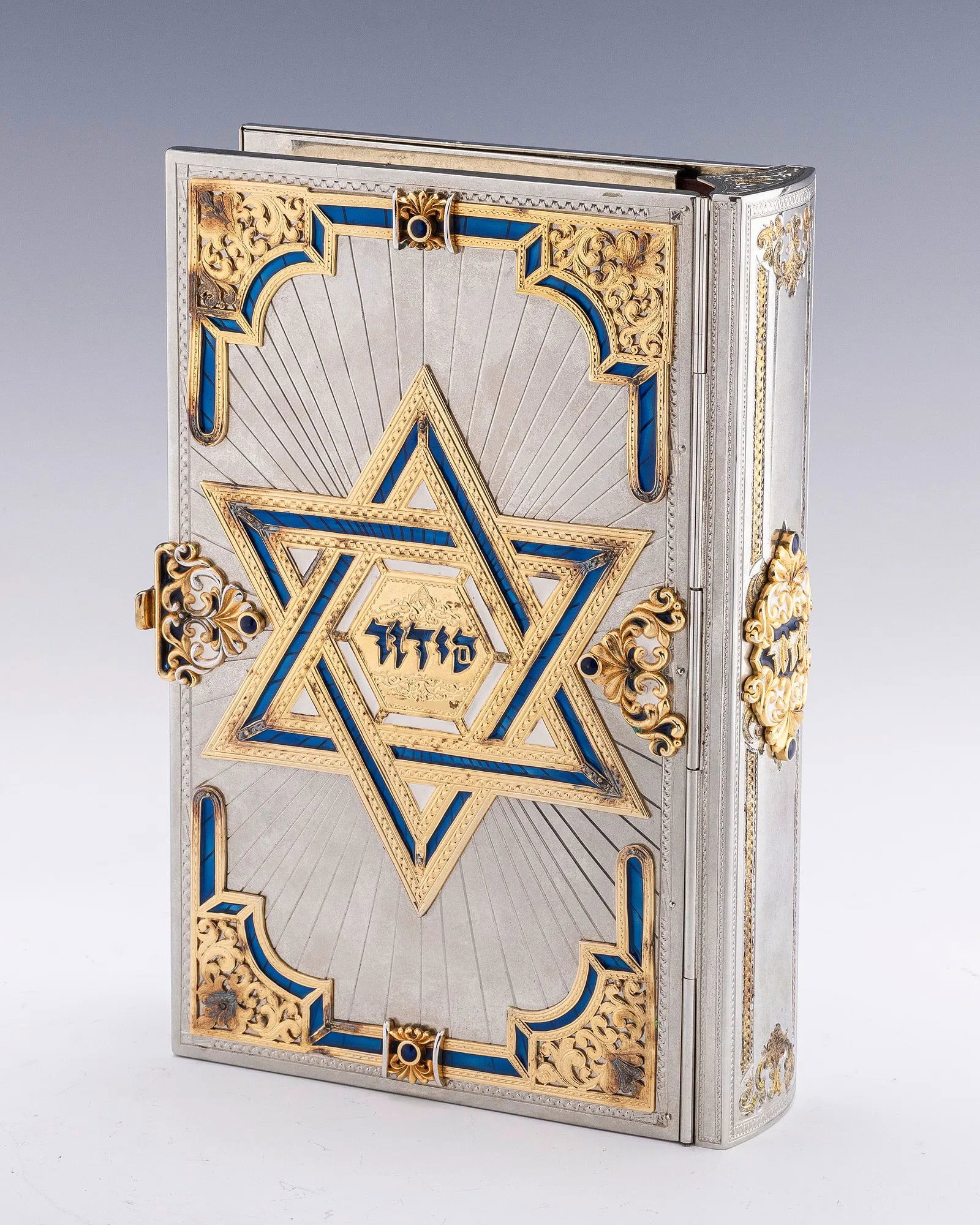 A STERLING SILVER, ENAMEL AND GILDED IDF SIDDUR BINDING BY YAAKOV DAVIDOFF. (1 of 3)