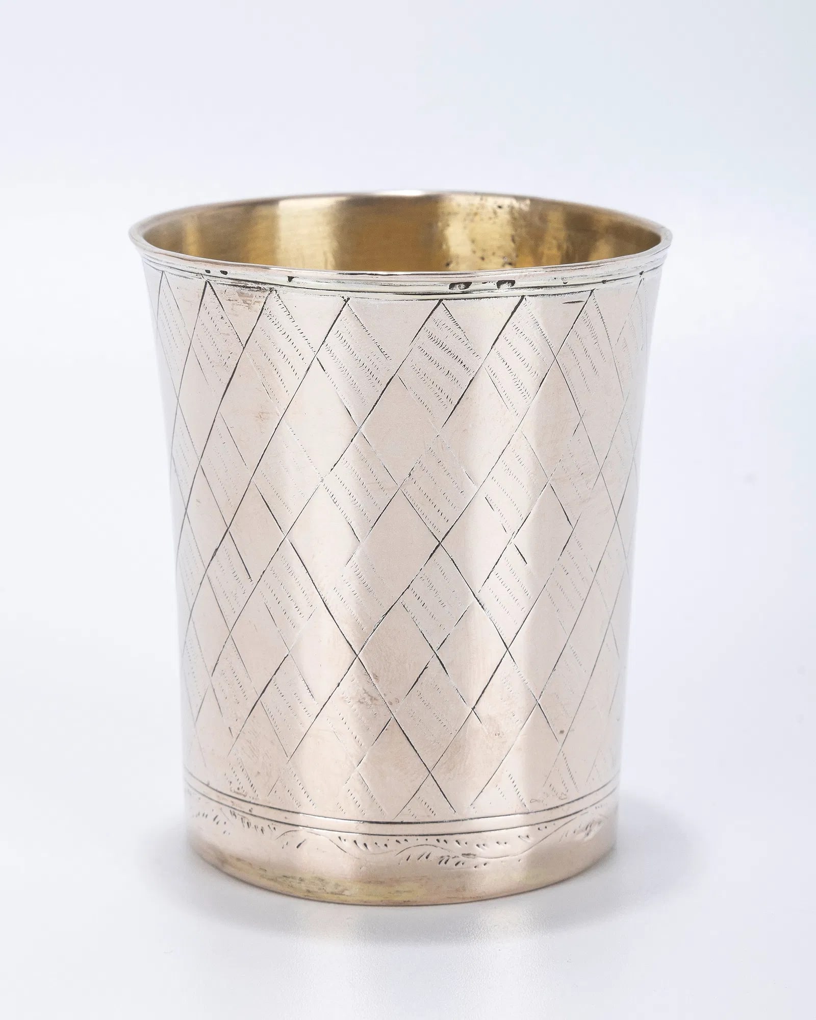 AN EARLY SILVER KIDDUSH CUP. Poland, 1844.: AN EARLY SILVER KIDDUSH CUP. Poland, 1844. Diamond shaped engravings on the body. With the former owner's name in Hebrew YOSEF BEN ZION and date of 1844 on base. Some solder repairs. 2.6" tall.