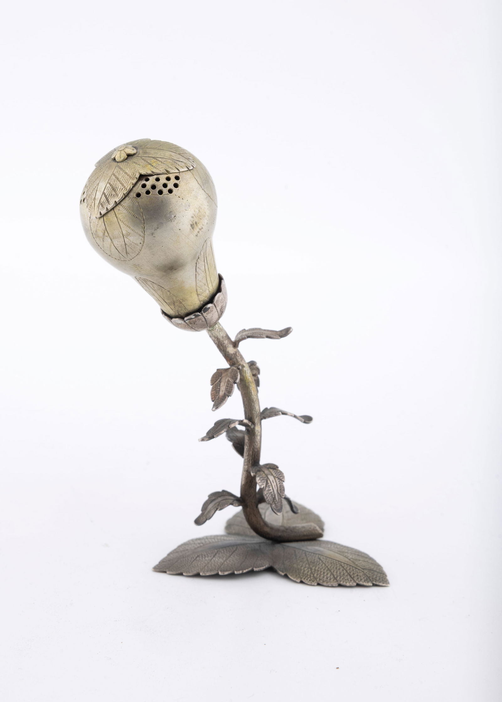 A SILVER SPICE CONTAINER. Poland, c. 1850: On a three leaf base with leave and branch shaped stem. Pomander shaped upper portion. 4.5" tall.