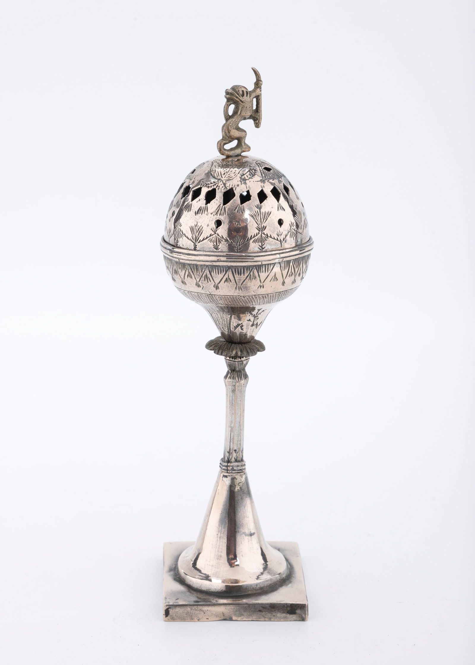 A SILVER SPICE CONTAINER. Poland, c. 1820: On a square base with inward tapering design. Upper portion hand engraved and hand pierced. Fitted with lion finial. 7.7" tall