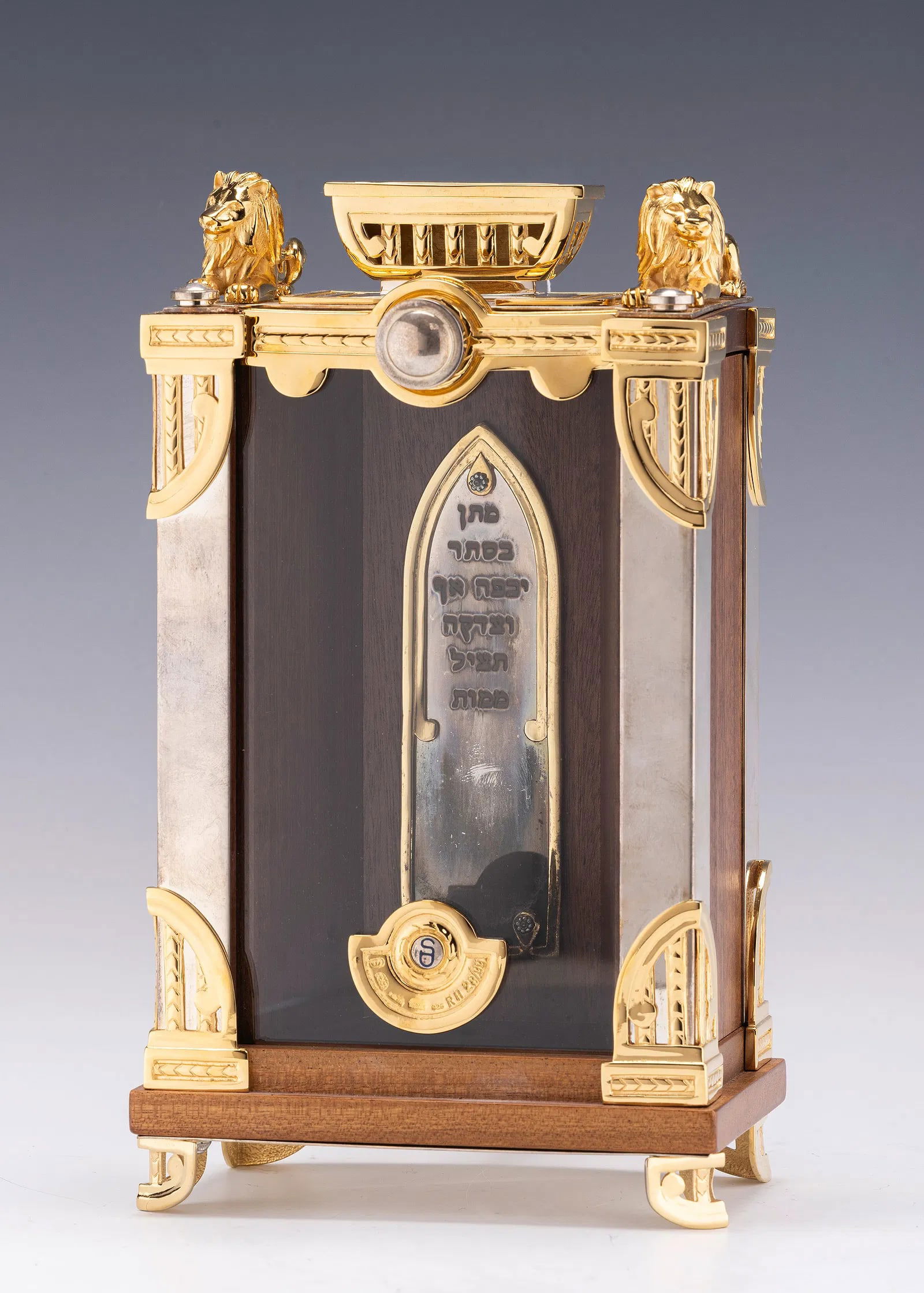 SWED MASTER SILVERSMITHS. (Jerusalem, c.2000) SILVER AND WOOD CHARITY CONTAINER.: On four gilded feet with a silver and wood body. Mounted with a handle for use in collecting finds. The upper portion is fitted with gilded lions and a coin slot. The inside is inscribed with CHARITY