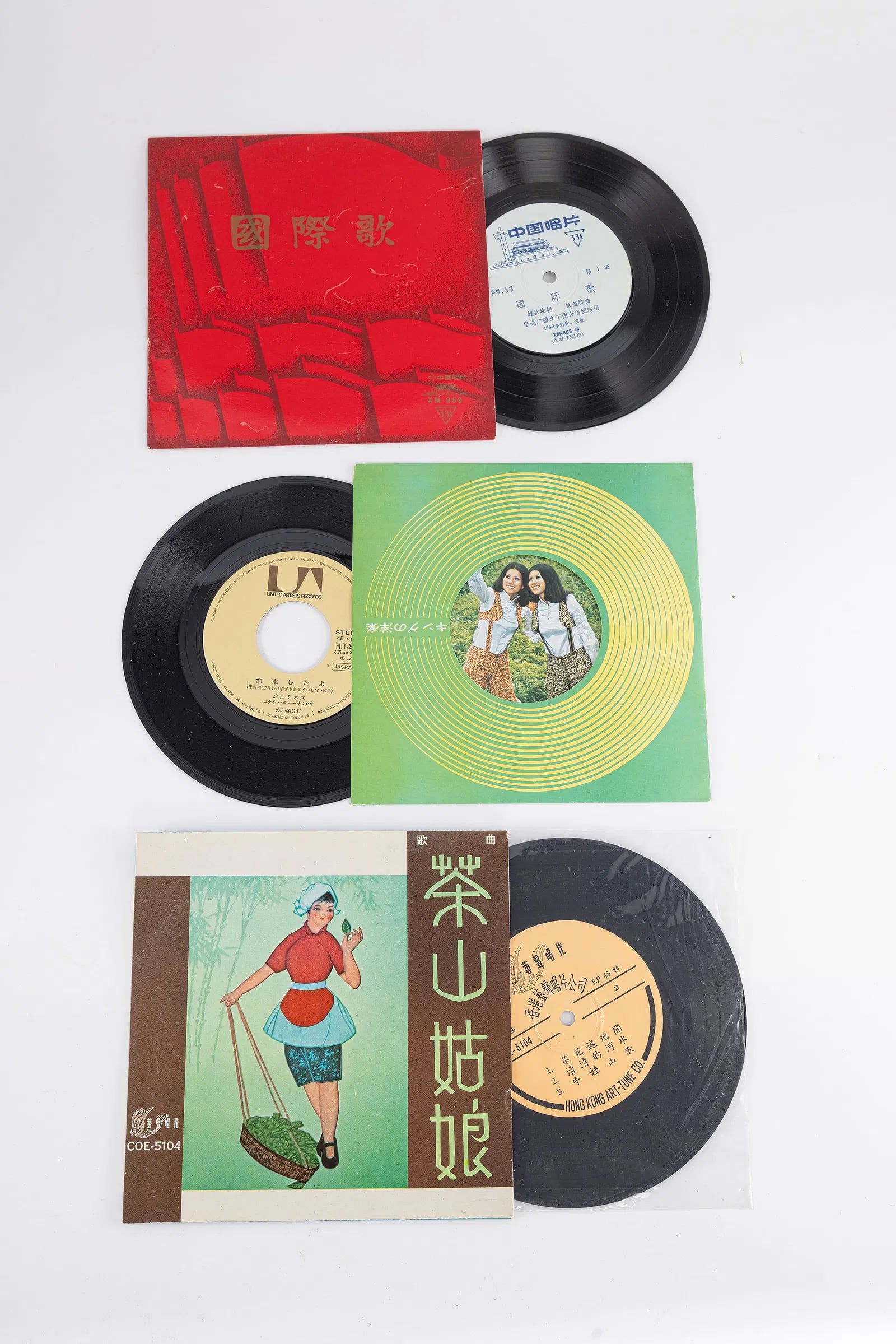A GROUP OF THREE MID CENTURY 45 RPM RECORDS. China, c. 1960: Each vinyl record is housed in the the original decorative sleeve