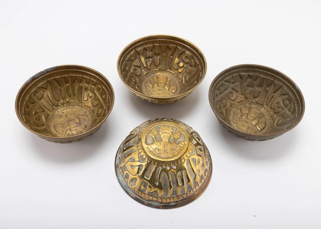 FOUR BRASS MIDDLE EASTERN BOWLS. Probably Syria, c. 1940: Each hand chased with Arabic inscription. Each is 5" in diameter