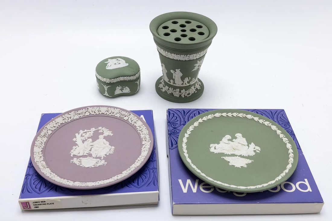 A COLLECTION OF FOUR WEDGEWOOD ITEMS.: Including a heart shaped box, a vase and two plates which are 6.5" wide each