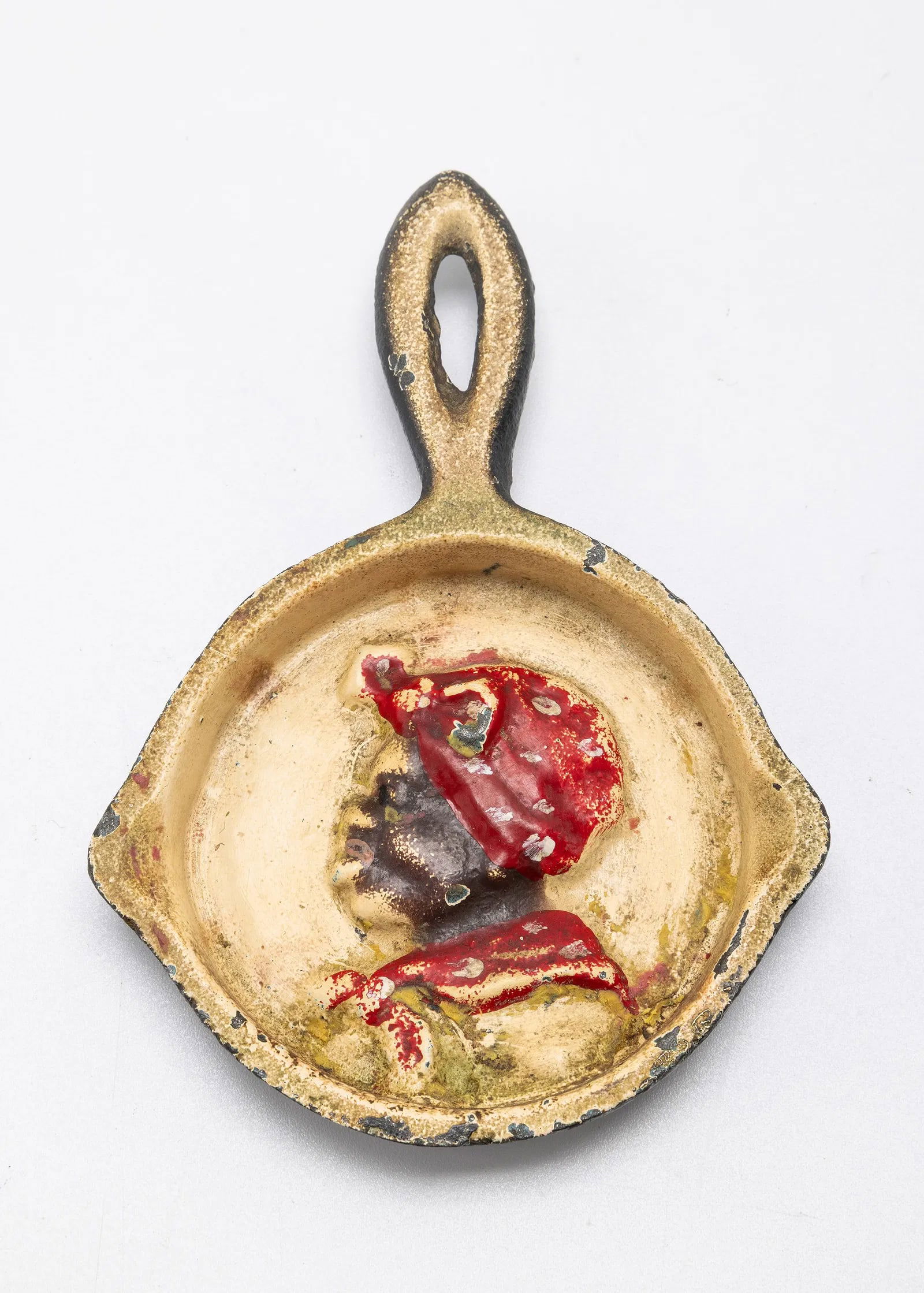 A CAST IRON SKILLET WITH AN AFRICAN AMERICAN WOMAN. American, c. 1900: Black Americana Era Cast Iron Skillet (Ash Tray). Marked JULA on bottom. 4.5" long