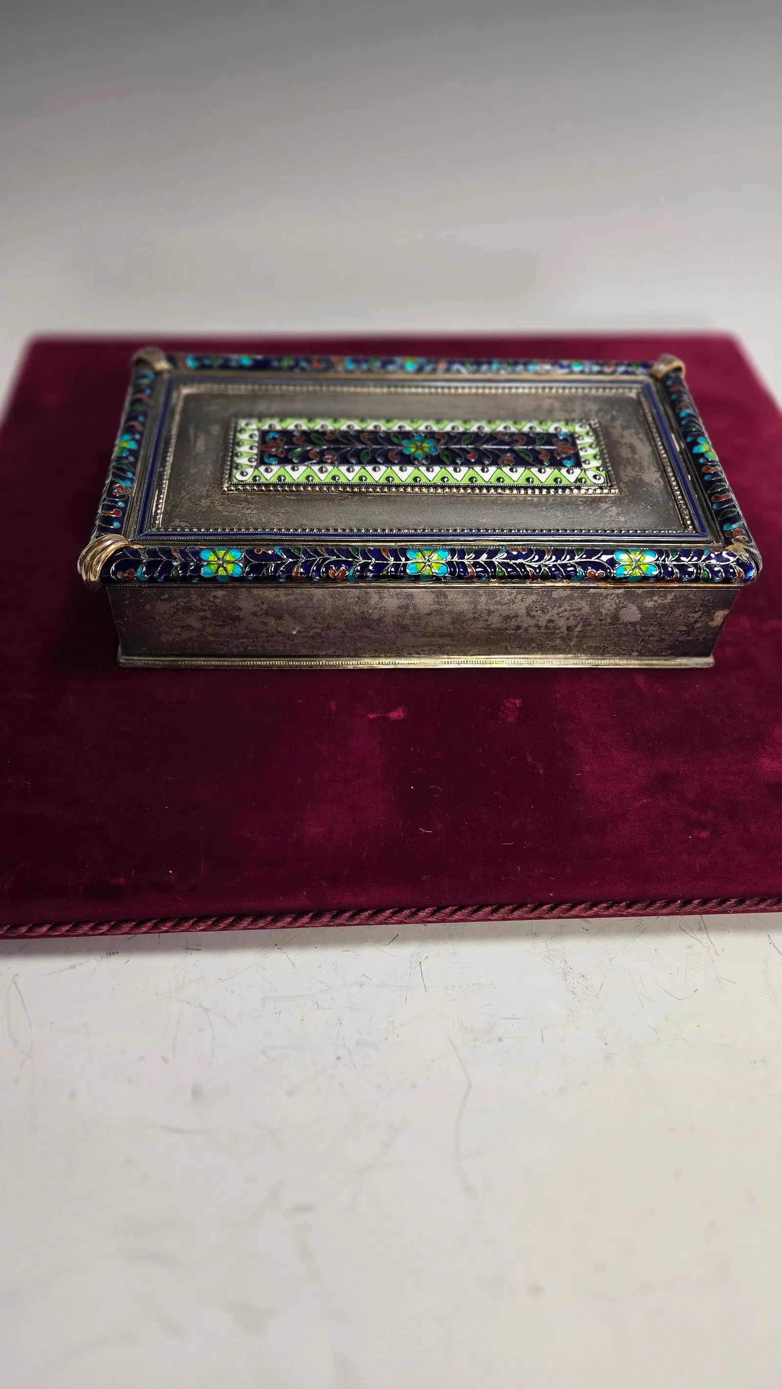 A MASSIVE STERLING SILVER AND ENAMEL JEWELRY BOX.: Rectangular in shape. Highly decorated with colorful enamel. Missing one decorative element from the corner, otherwise magnificent. 53 ozt. 9" x 5" x 2"