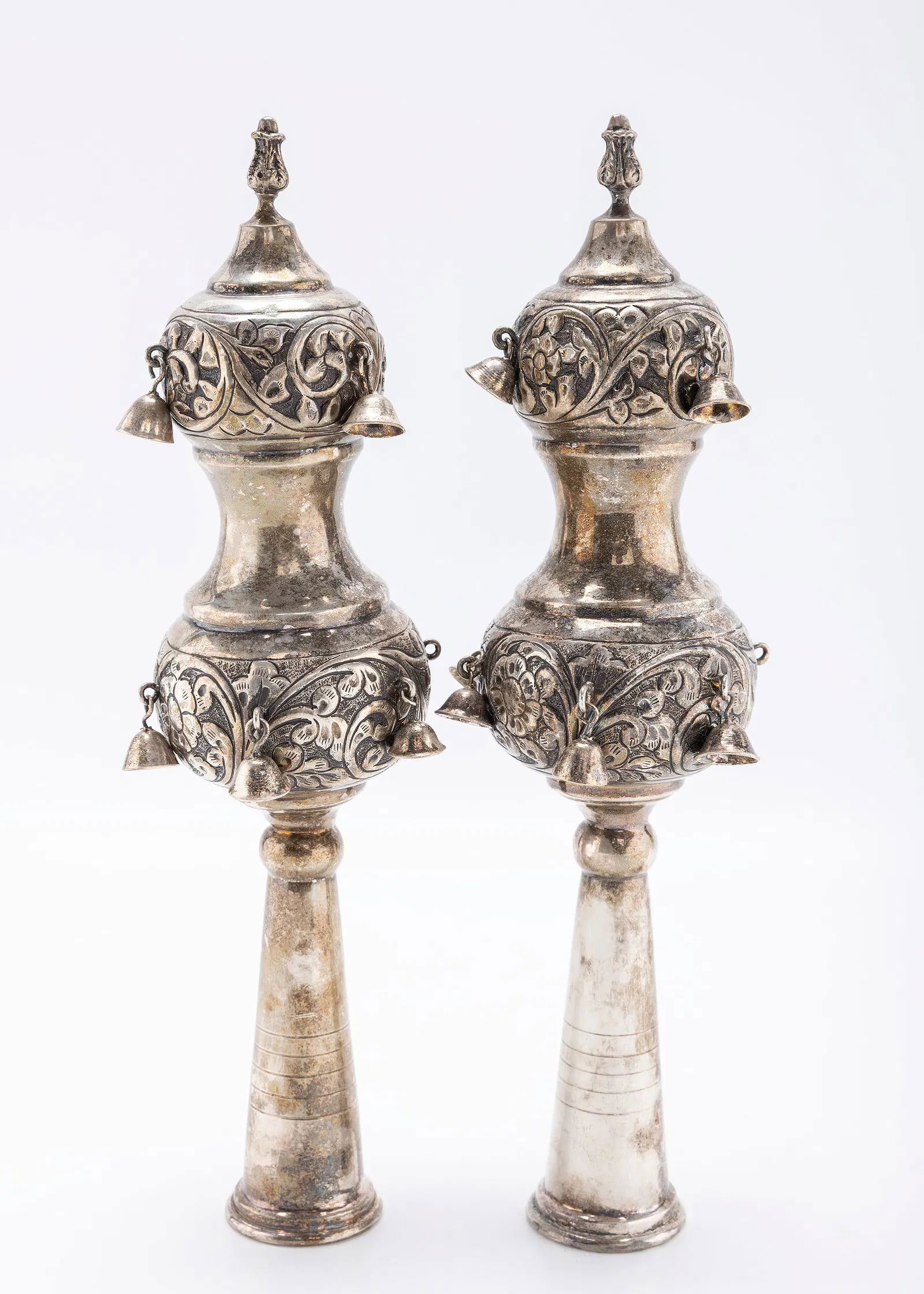 A PAIR OF STERLING SILVER TORAH FINIALS. Israel, modern.: Hand chased in bulbous form. Fitted with bells. 600grams and about 12" tall.