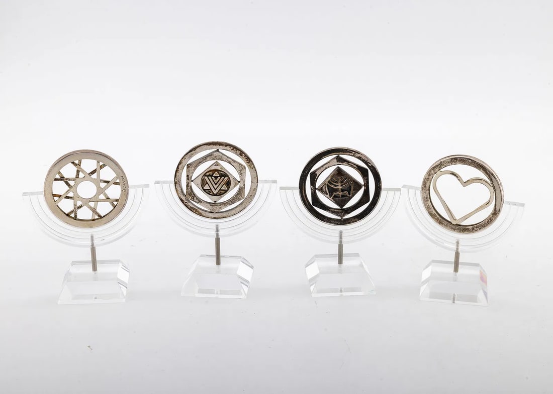 FOUR STERLING SILVER DECORATIVE KINETIC MEDALS: Israel, c. 2000. By Naim Basson. Each one approximately the shape of a silver dollar