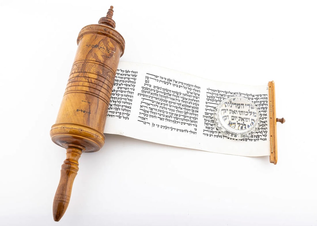 A LARGE MEGILLAT ESTHER IN ORIGINAL OLIVEWOOD CASE. Palestine, c. 1920.: The main body is carved with Holy Land scenes and imprinted with the locations descriptions in black Hebrew. Well written black Sephardic ksav. 15.5” long.