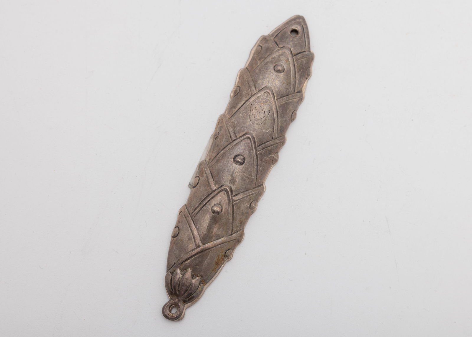 A STERLING SILVER MEZUZAH COVER BY TIFFANY AND COMPANY: New York, c. 1990. Layered (like and artichoke) design, with a shin. Marked. 4.7" long