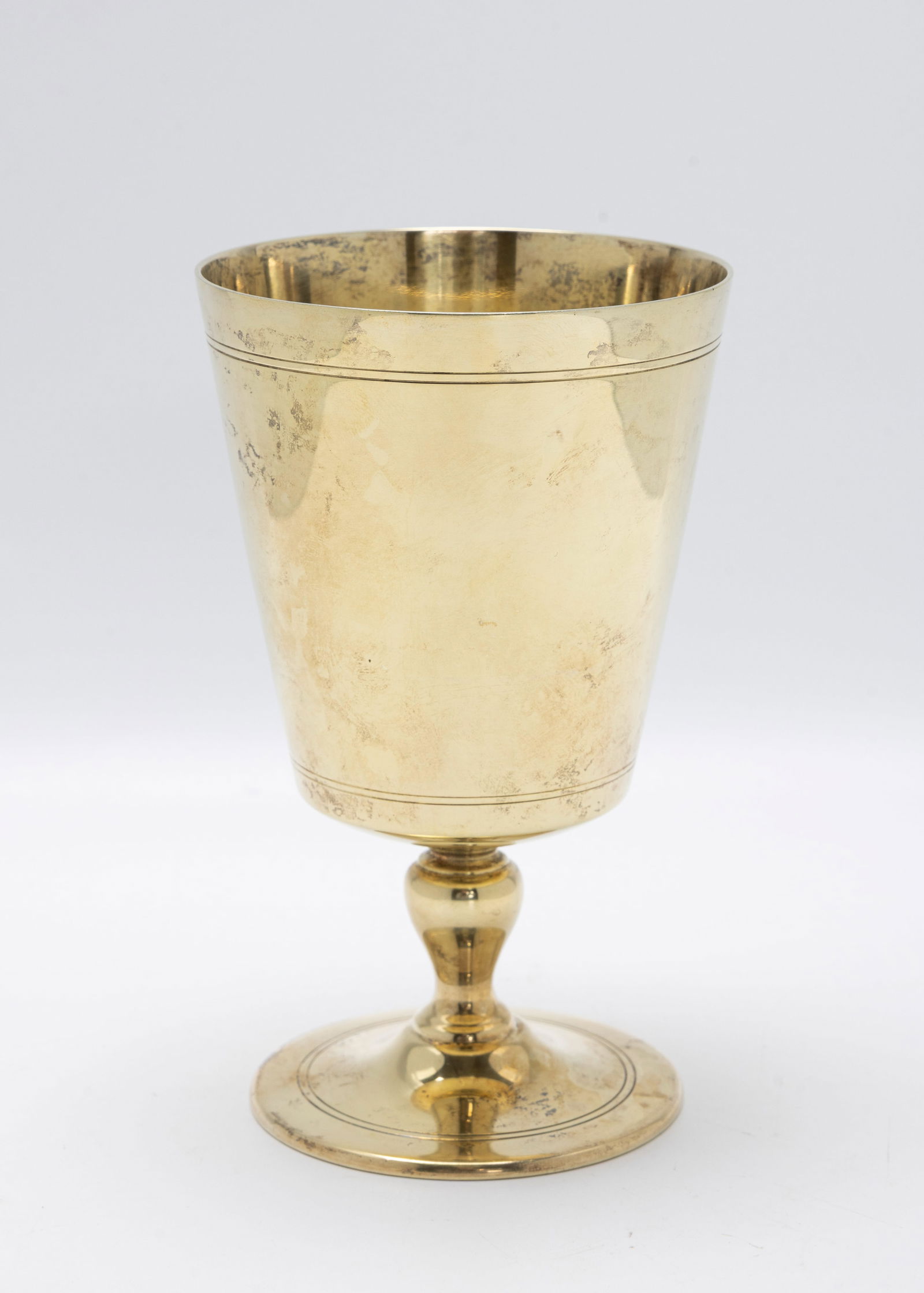A PARCEL GILD STERLING SILVER KIDDUSH CUP BY TIFFANY AND COMPANY.: New York, c. 1990. Traditional form goblet. 5.5" tall and 231.4 grams