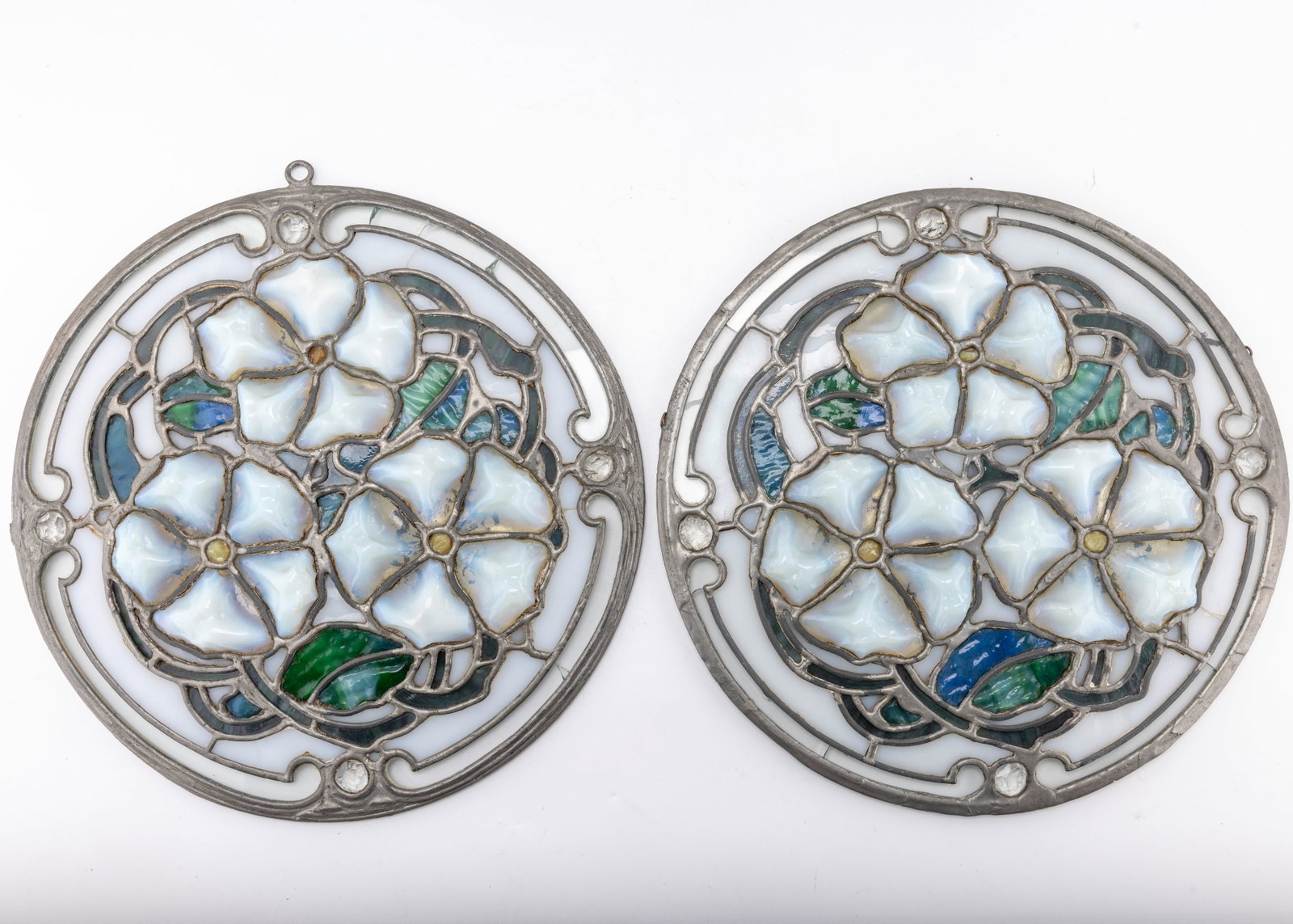 ELEANOR ROOSEVELT ESTATE - STAINED GLASS WALL HANGINGS (2): Hand crafted and joined with lead. With the original sticker on the verso indicating it was from the Estate of Franklin Deleno and Eleanor Roosevelt's estate. 11.3" diameter each.