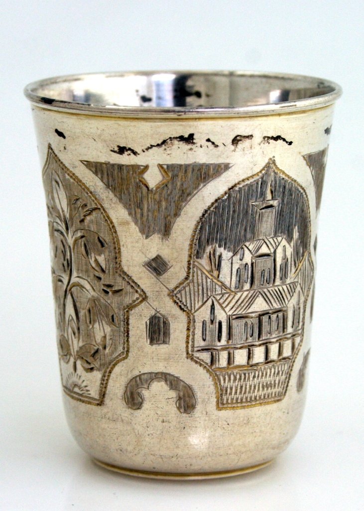 A SILVER KIDDUSH BEAKER. Russian, 1885. Engraved with t: A SILVER KIDDUSH BEAKER. Russian, 1885. Engraved with town and floral decorations. Marked. 2.3” tall.