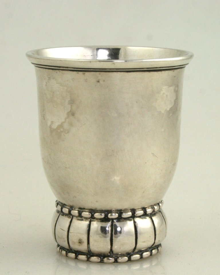 A Silver Beaker. Denmark, C. 1900. With Beaded Border A: A SILVER BEAKER. Denmark, c. 1900. With beaded border and hand hammered finish. Marked. 3.3” tall.