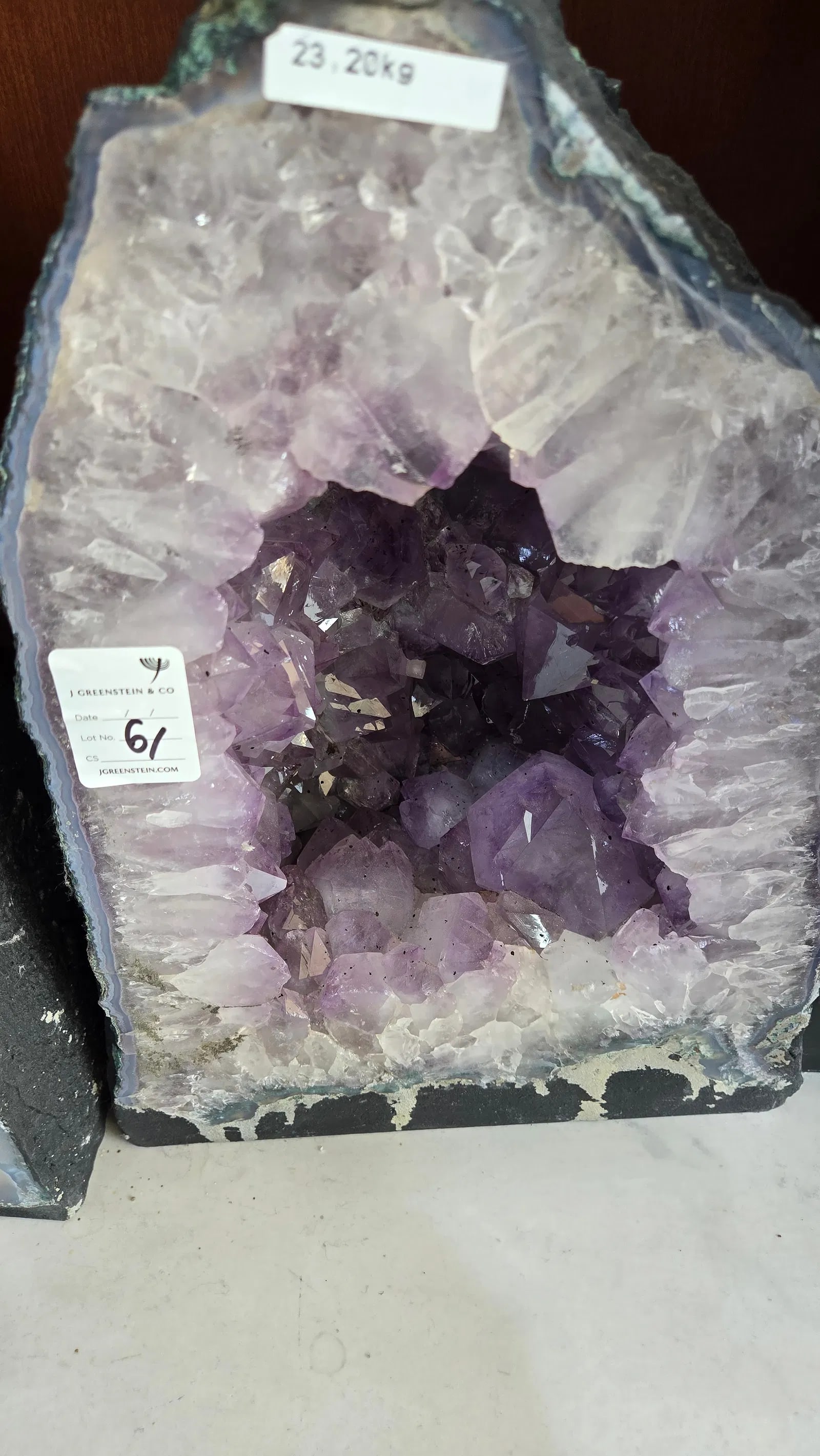 A LARGE AMETHYST GEODE POLISHED EDGES: 23.2 KILOGRAMS AND 15" TALL. light blue in color. deep cavelike