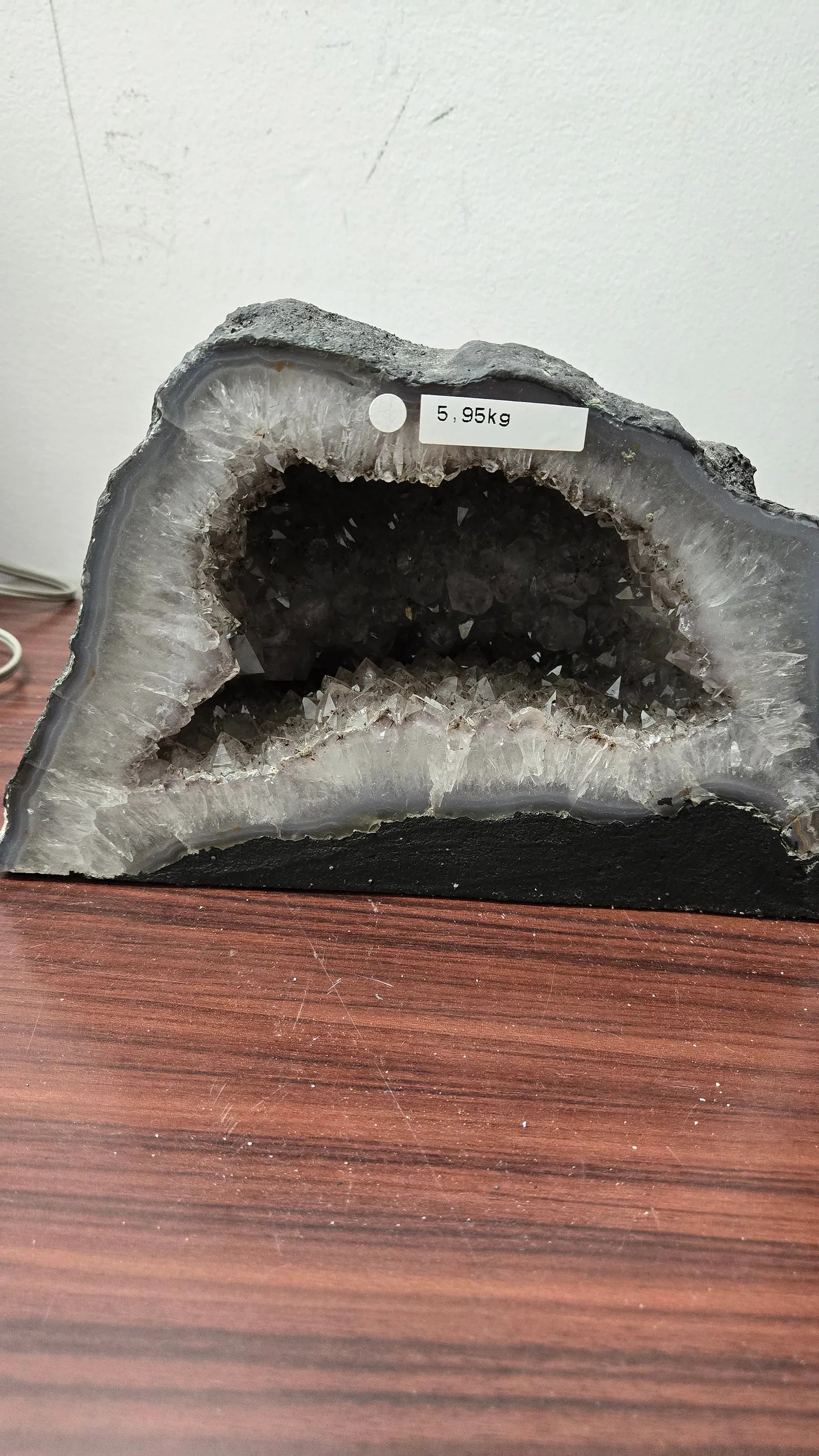 AN AMETHYST GEODE WITH POLISHED EDGES.: In traditional form. 5.95 kilograms and 6.5 tall