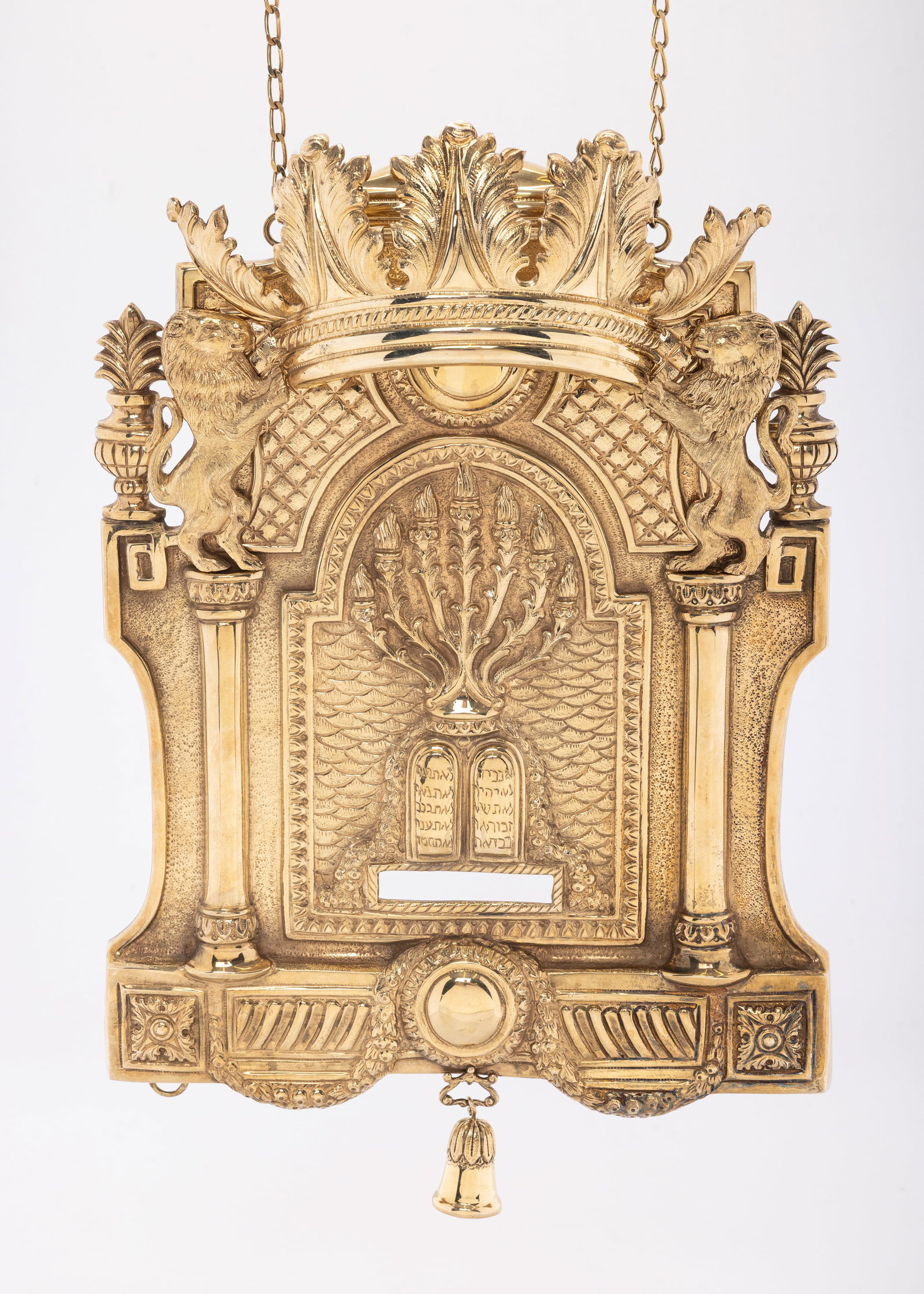 A STERLING SILVER TORAH SHIELD BY MICHAEL STRAUSS SILVERSMITH. Portugal: Modern. In classic German form. Hand wrought, hand engraved and hand hammered and tooled. Decorated with the Decalogue and a menorah. Signed. 13" long and 955 grams