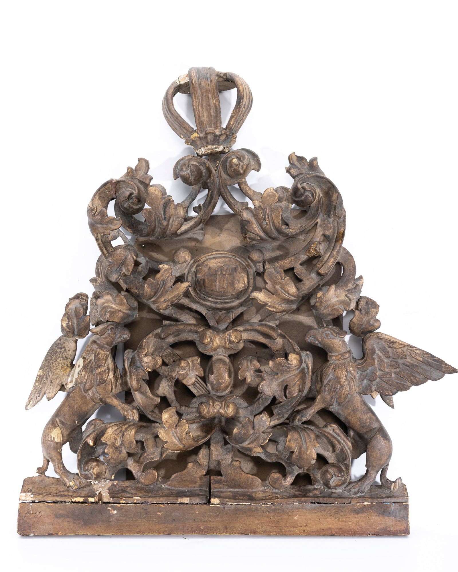A MAGNIFICENT WOODEN ARK DECORATION. Poland or Romania, c. 1850: Baroque in design. Decorated with winged griffons, scrolling designs and flowers. Central cartouche with G-d's name. 26" x 28.5"