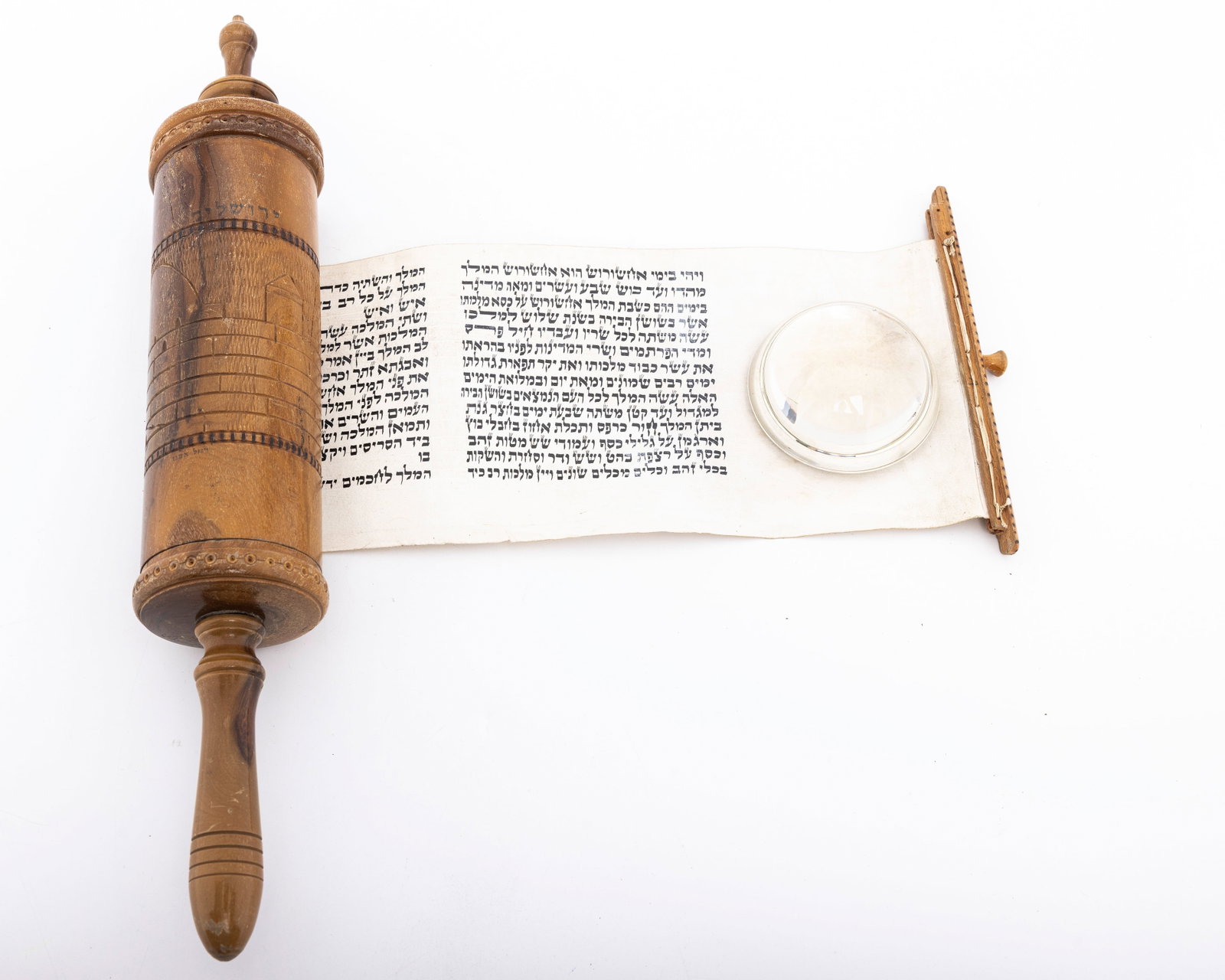 AN OLIVEWOOD MEGILLAH CASE WITH ORIGINAL MEGILLAH. Jerusalem, c. 1930: Hand engraved olive wood body, decorated with Old City scenes. Fitted with the original megillah in Sephardic ksav. 16.5" long