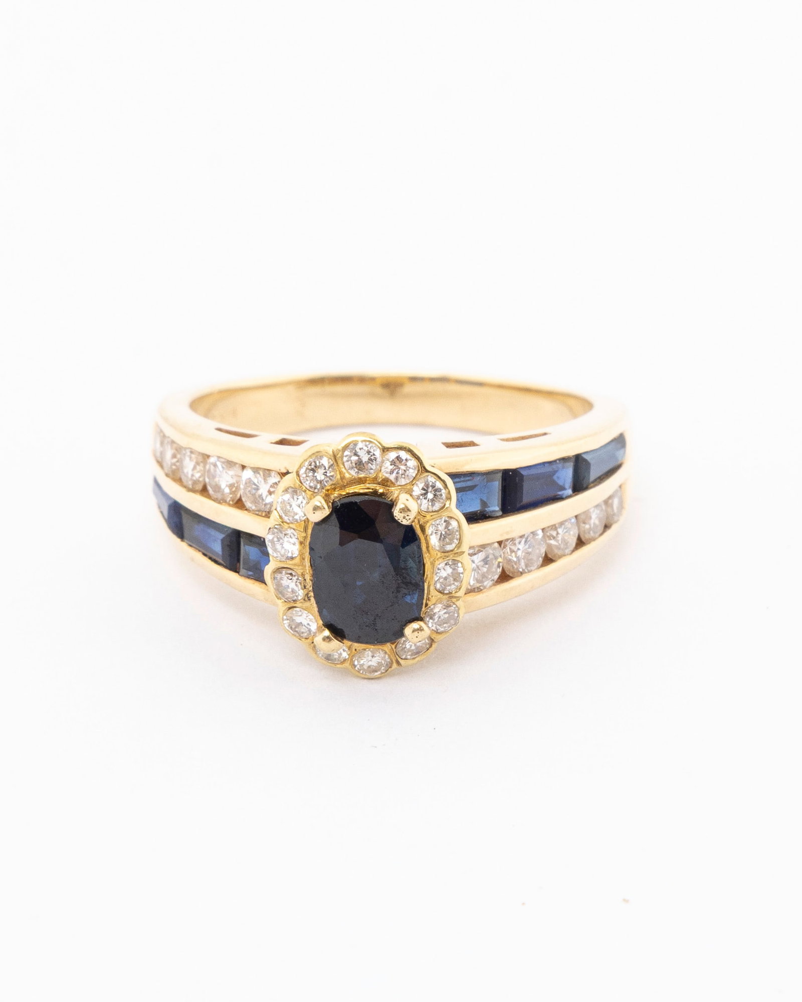 AN 14K DIAMOND AND SAPPHIRE RING.: The center stone is .16 with small diamonds. 4.2 dwt