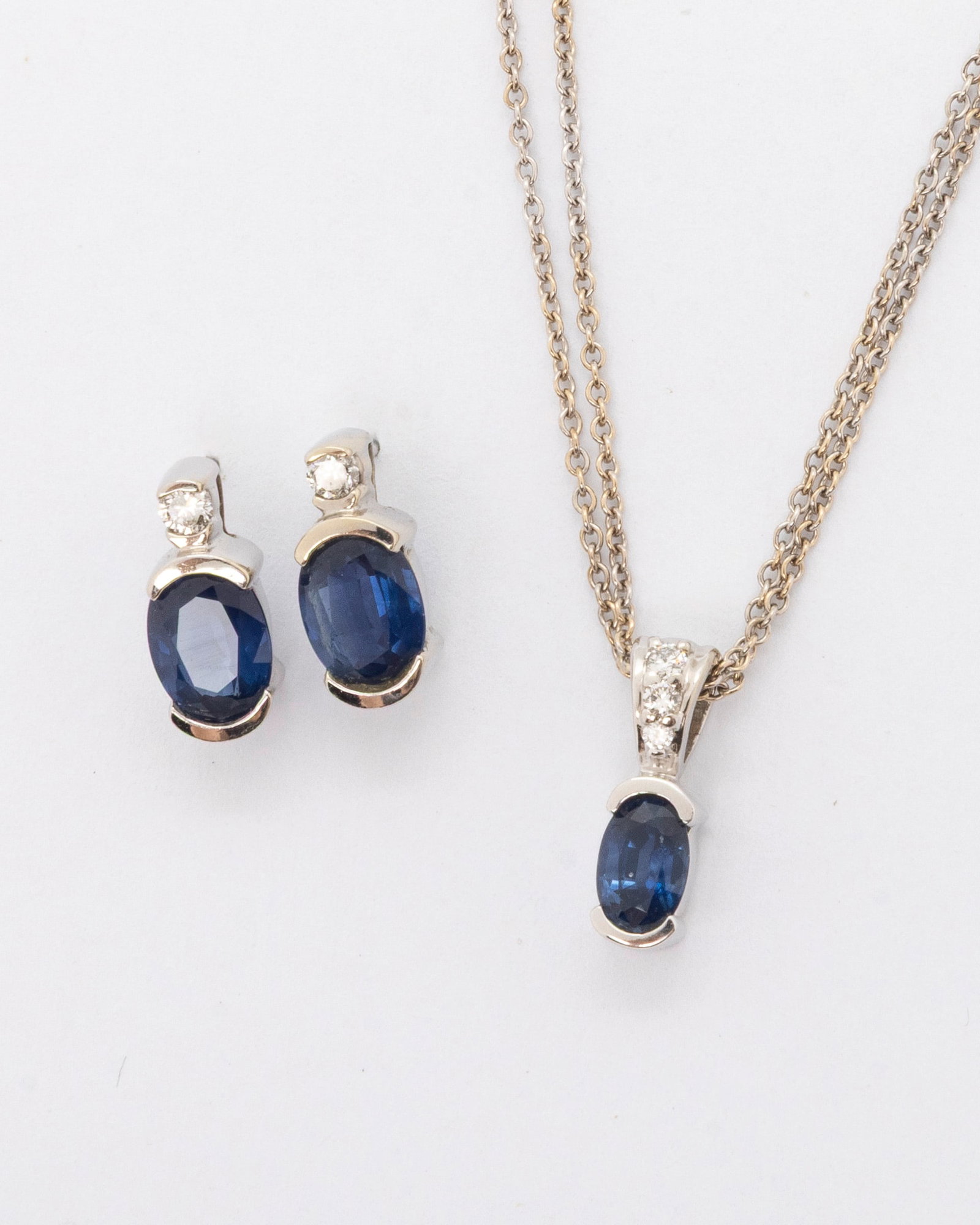 AN 14K DIAMOND AND SAPPHIRE PENDANT WITH CHAIN: 14K pendant with sapphires. Accompanied by a pair of matching earrings Supported with a double chain. Total weight about 3 carat. 4.2 dwt.