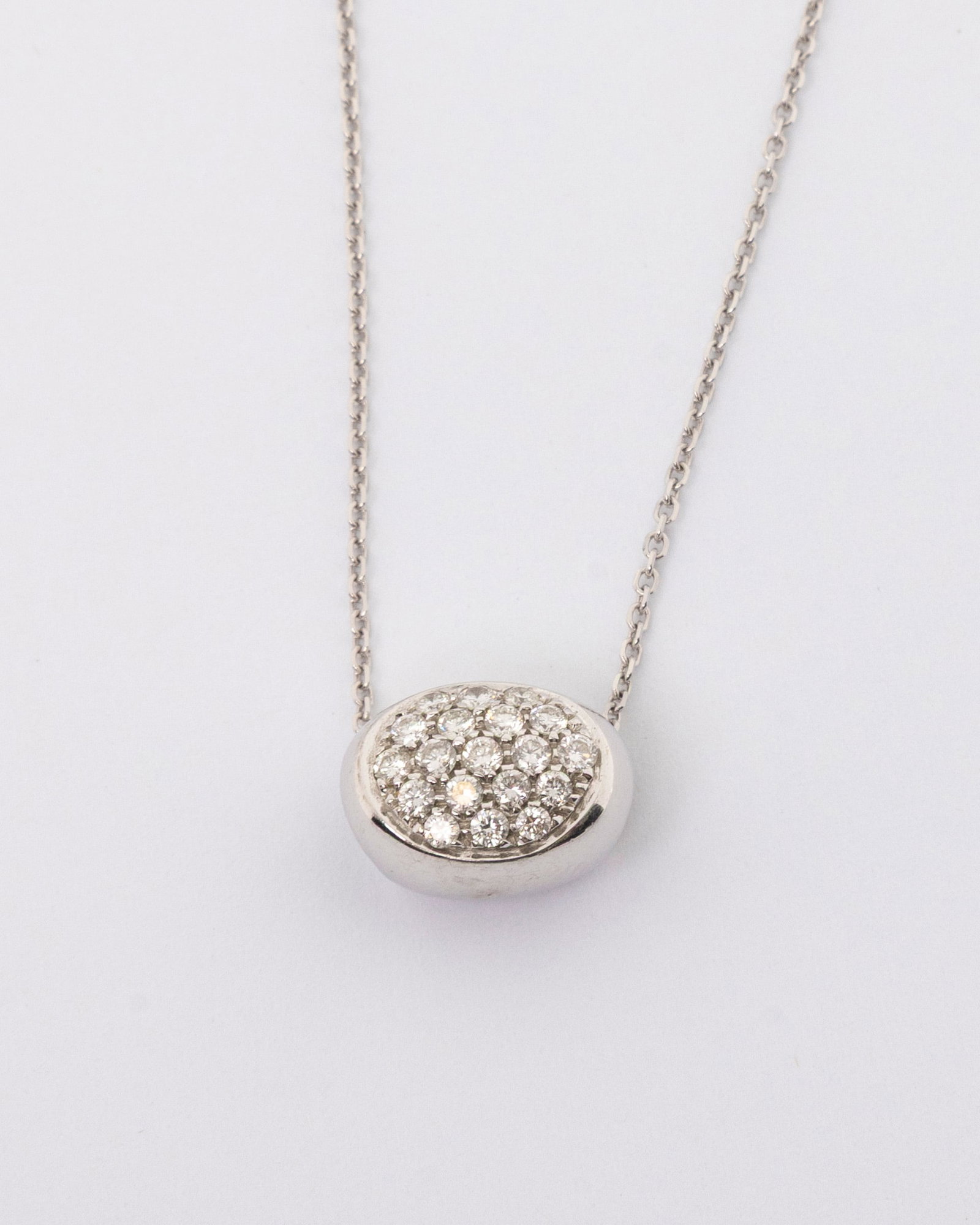 AN 18K WHITE ITALIAN DIAMOND PENDAND AND NECKLACE: 18k white gold Italian diamond pendant with a 14K chain. 19 diamonds. 3.5 dwt