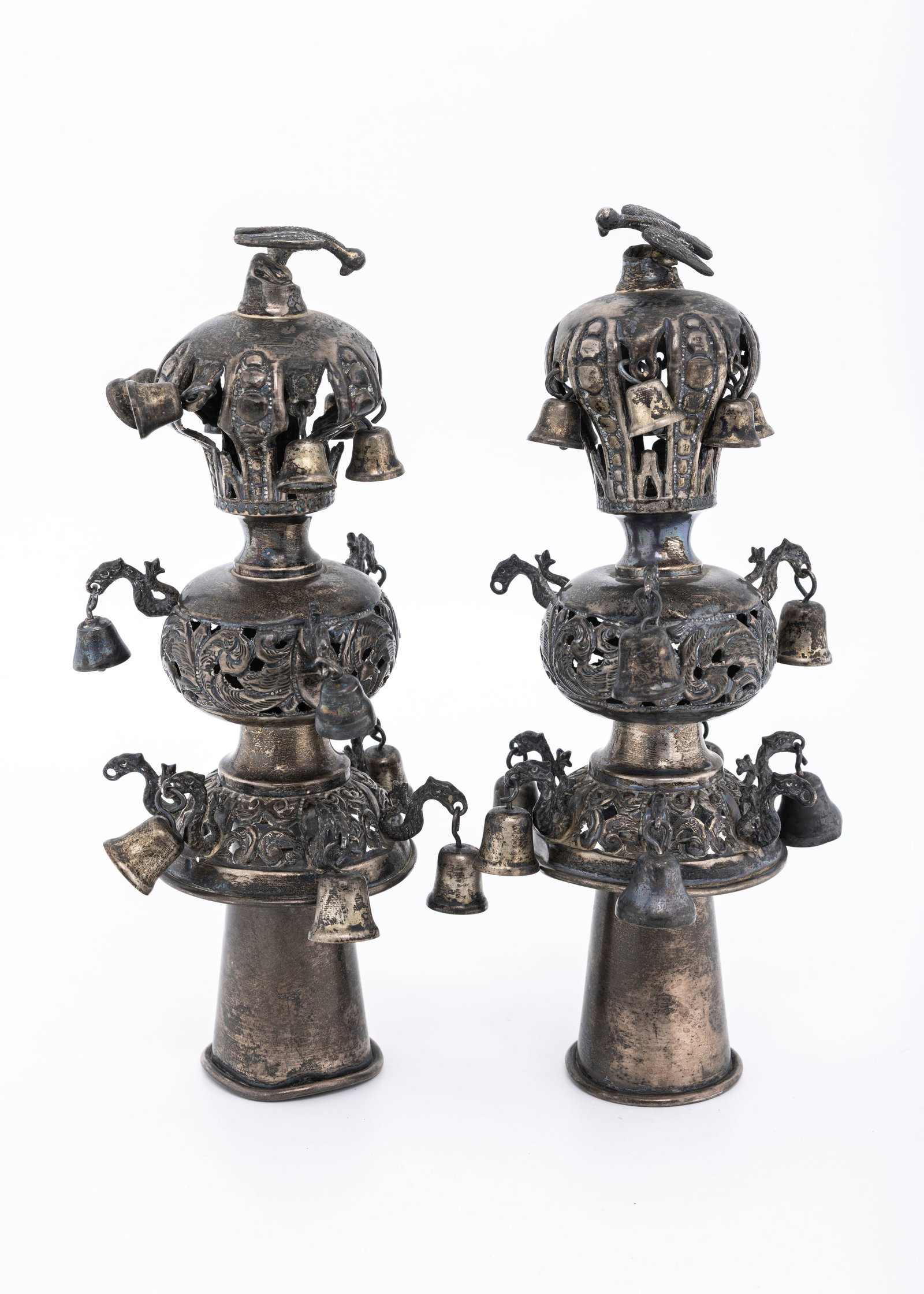 A PAIR OF ANTIQUE STERLING SILVER TORAH FINIALS. New York, c. 1900: Tradtional form. Hand cut and hand chased. Fitted with a crown and a bird finial. 9" tall. Total weight is 477 grams