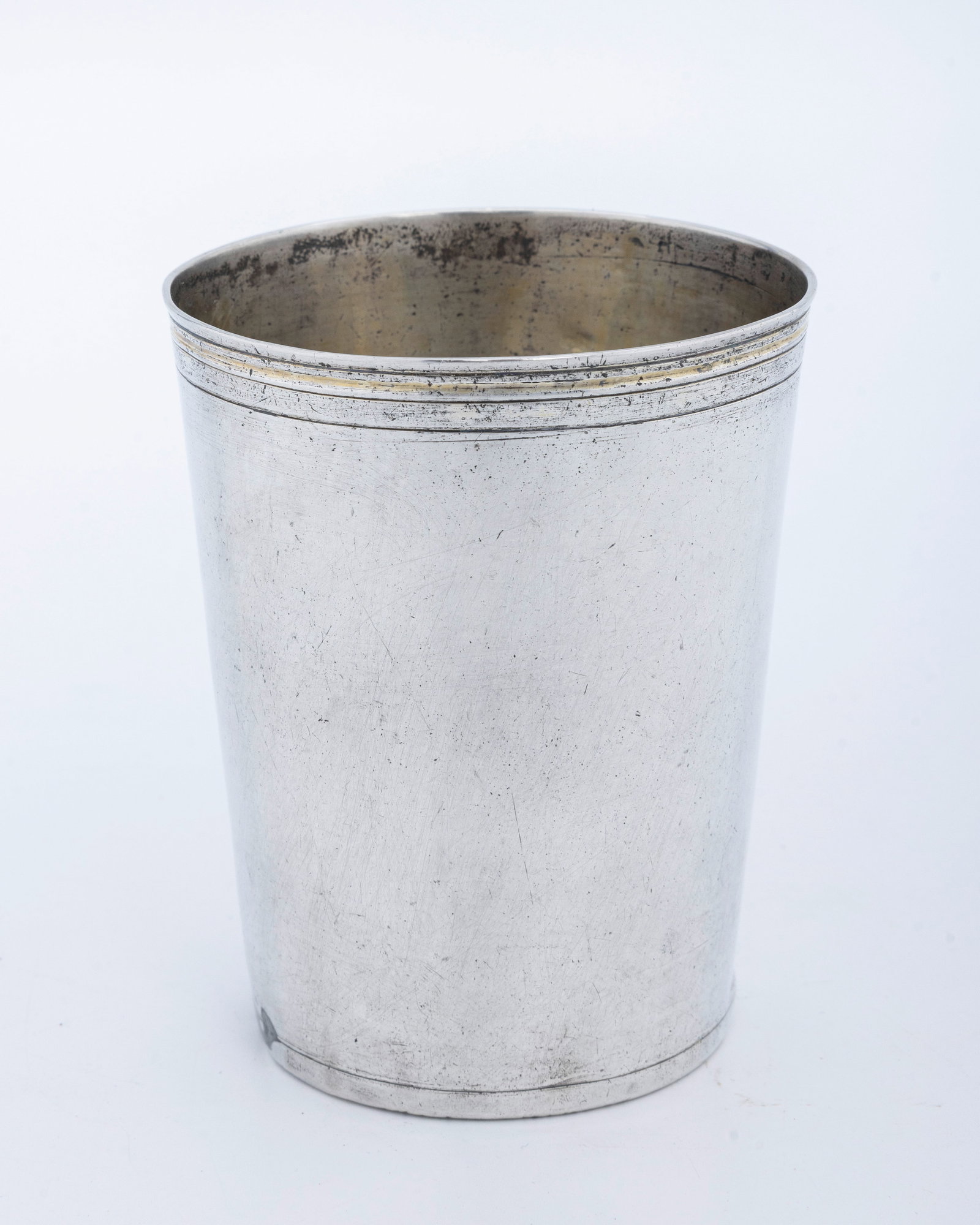 A LARGE SILVER GERMAN BEAKER. Augsburg, 18th century.: Beaker form. The outside with a smooth finish. Marked with Augsburg pineapple mark with an H and a maker's mark of CXS. Old lead solder repair to the base. 3.5" tall and 100.4 grams.
