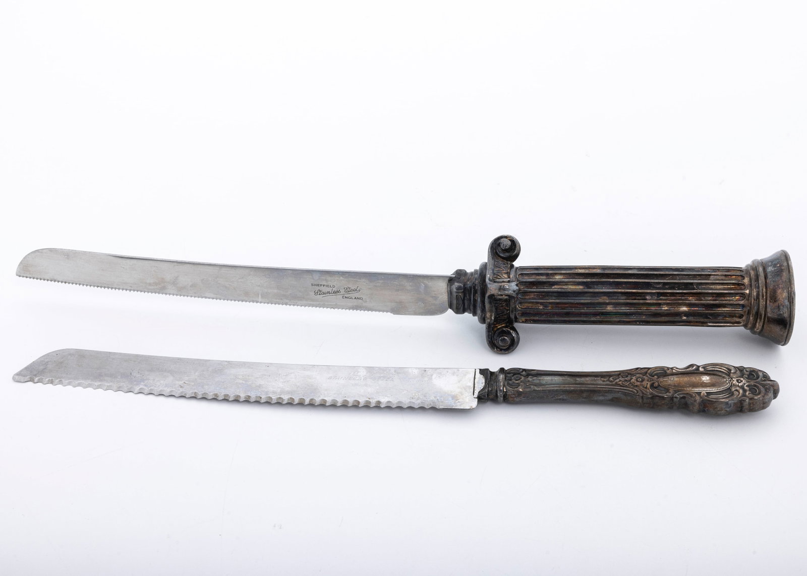 TWO STERLING SILVER HANDLED CHALLAH KNIVES.: American or Israeli. Modern. With sterling silver handles and steel blades. The largest is 14".