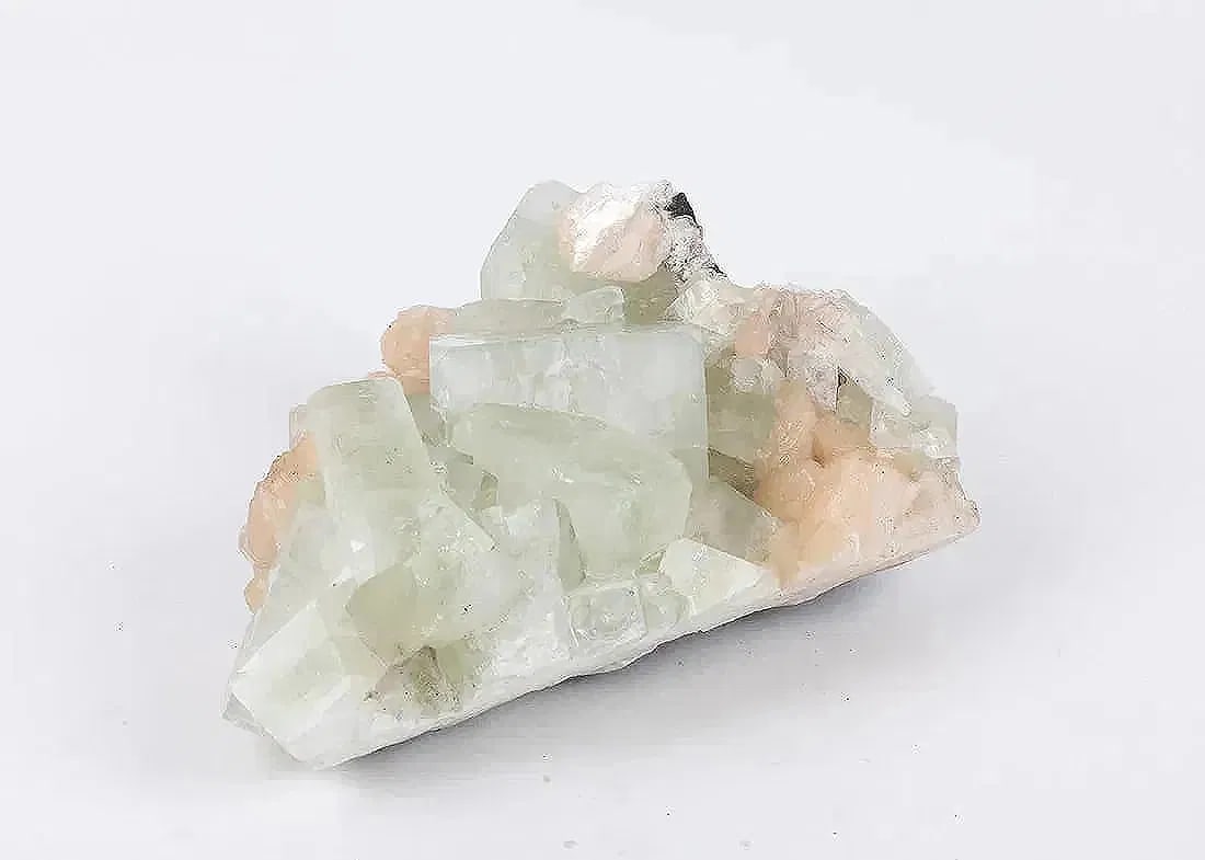 AN APOPHYLLITE SPECIMEN: 4.7” x 4.5” x 7.1”. The weight is 3131.6 grams.
