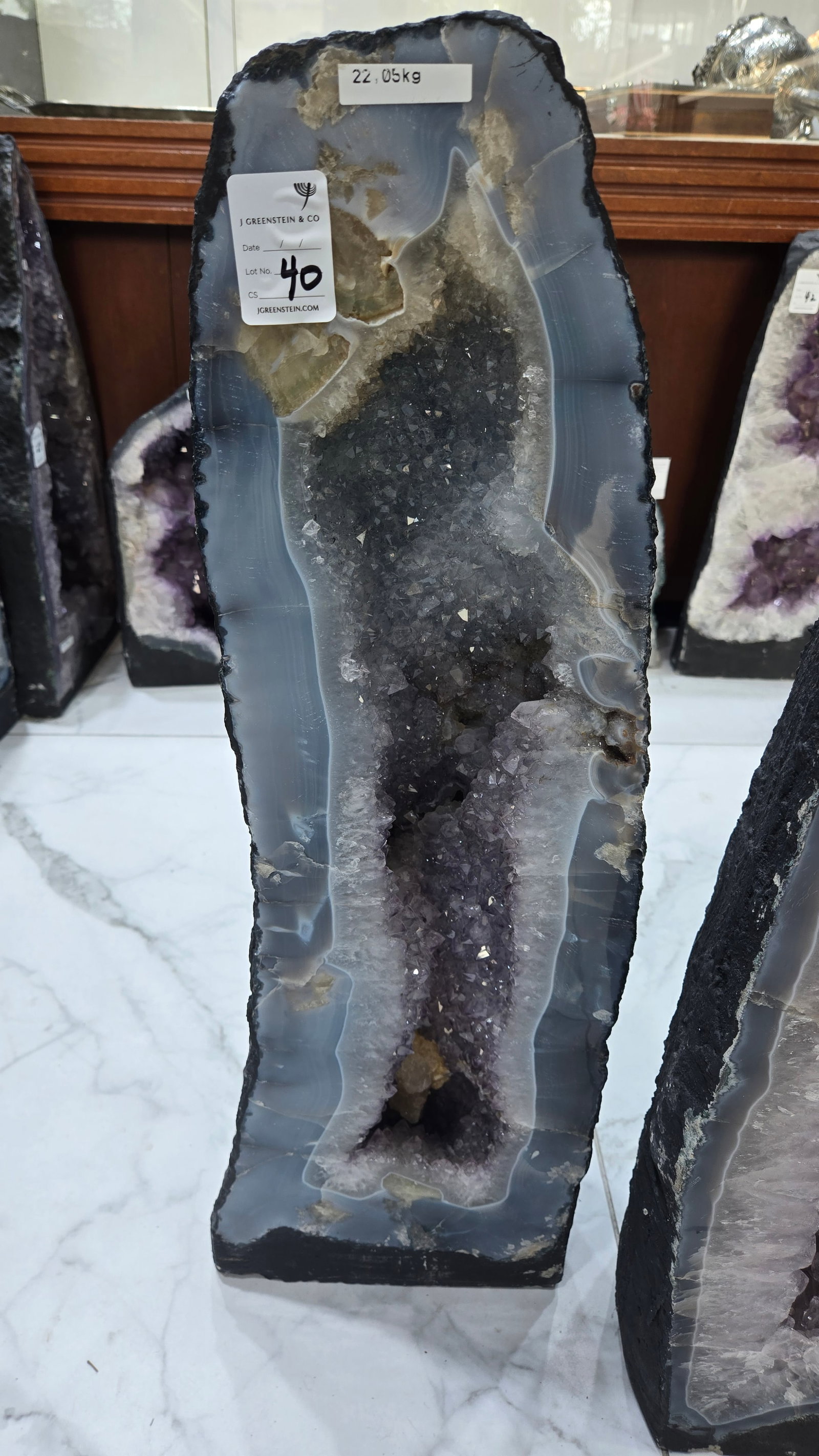AN AMETHYST GEODE WITH POLISHED EDGES.: Nice grey color on the outer periphery. 22.06kg and 26" tall