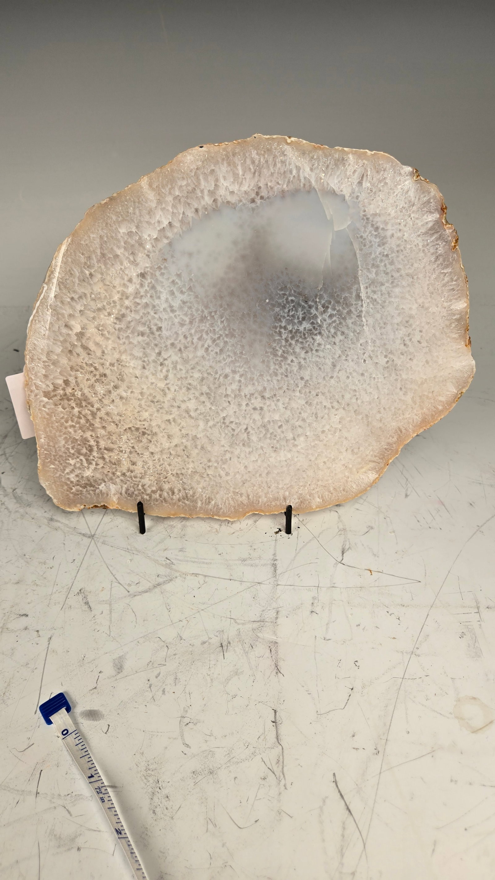 A LARGE WHITE AGATE SLICE.: 9" across. Higly polished.