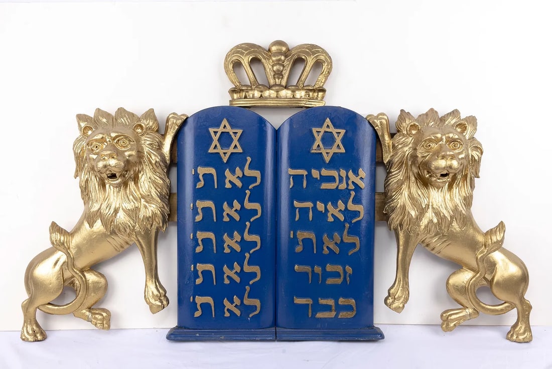 A LARGE PAIR OF WOODEN TORAH ARK LIONS. American, 20th century. Blue painted Decalogue flanked by: A LARGE PAIR OF WOODEN TORAH ARK LIONS. American, 20th century. Blue painted Decalogue flanked by two outwardly facing lions. 45” x 27”.