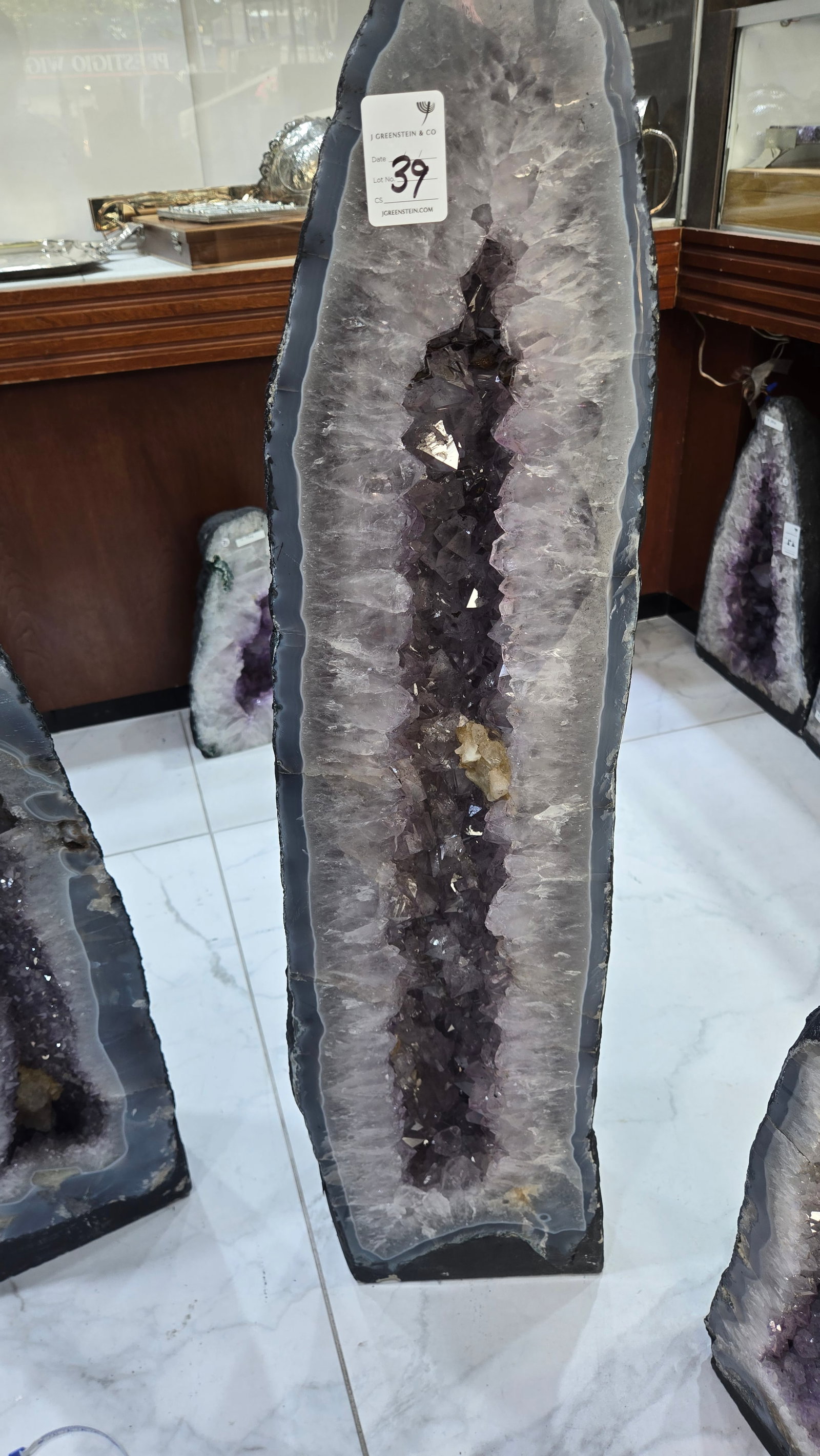 AN AMETHYST GEODE WITH POLISHED EDGES - GORGEOUS: 39kg and 34" tall. Nice color and clarity to the stones.
