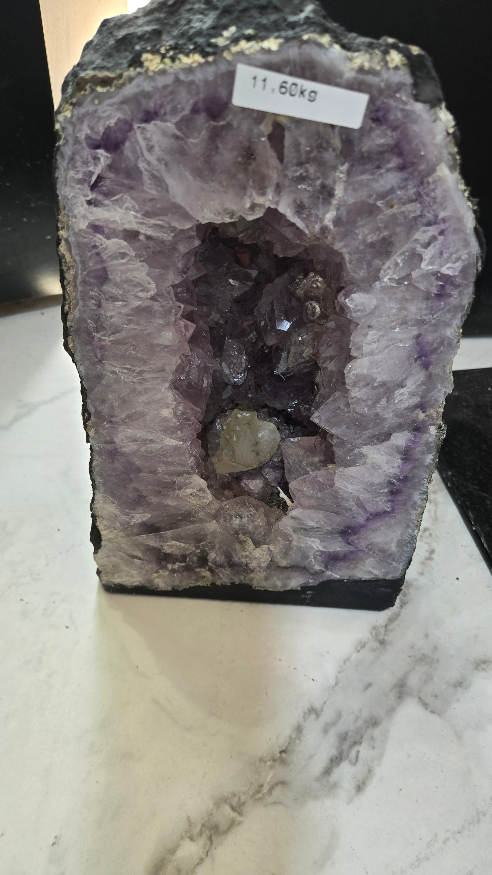 AN AMETHYST GEODE WITH POLISHED EDGES: 11.6 kg and 11.5" tall.