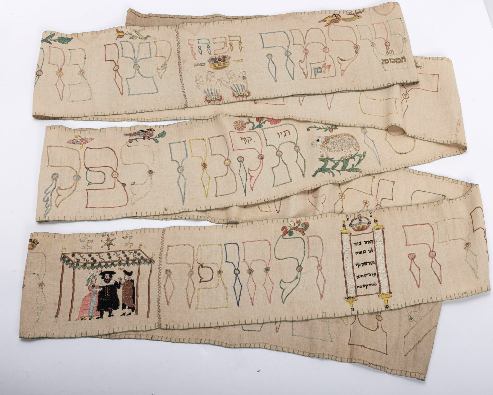 A RARE AND IMPORTANT TORAH WIMPLE. Germany,: Exceptionally well embroidered with scenes of Cohanic (Priestly) hands under a crown, Pomegranetes, flowers, a sheep, birds, a tall German sefer torah, a chuppah scene in period garb.