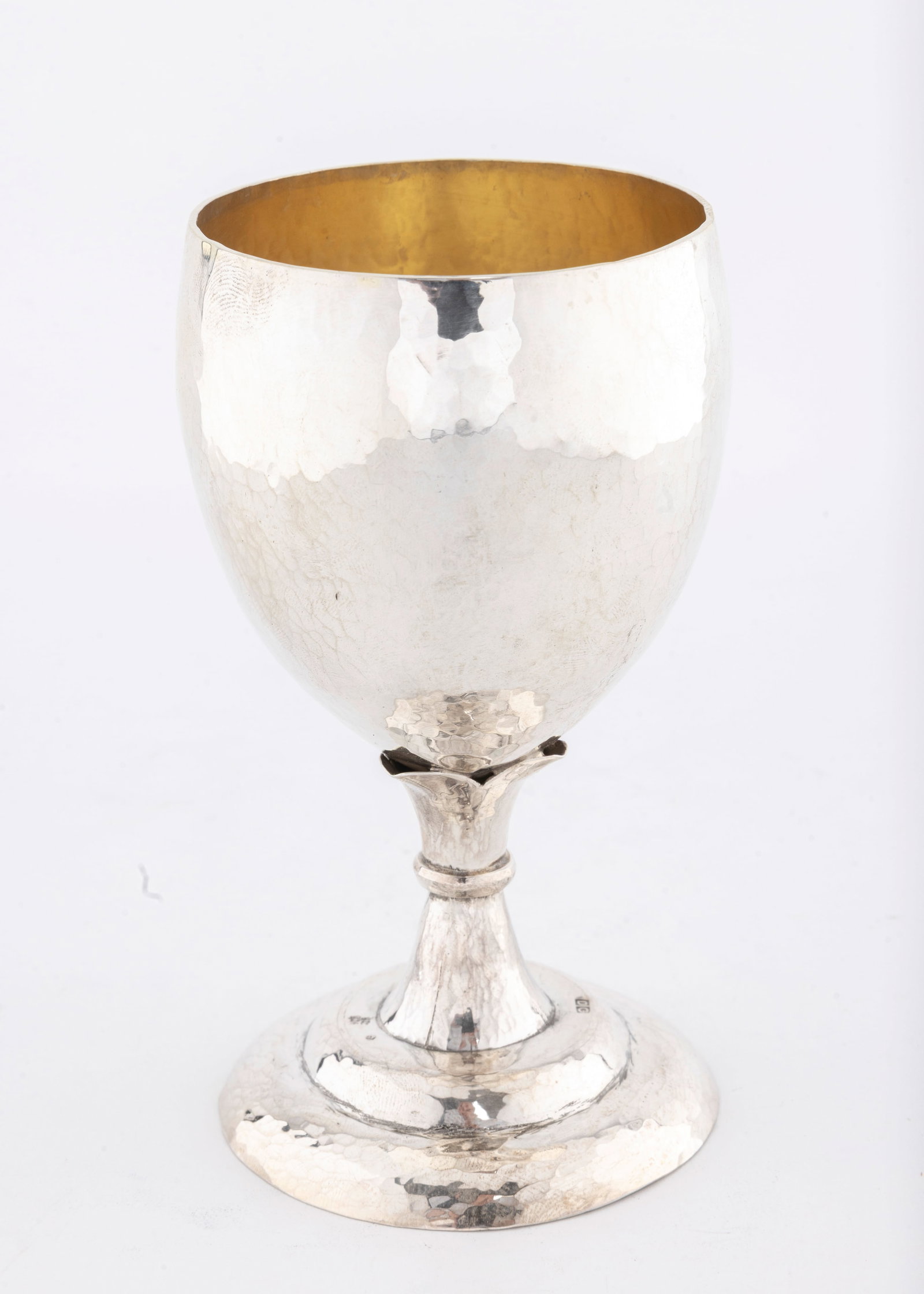 A HAND WROUGHT STERLING SILVER KIDDUSH CUP BY DOVID COHEN. Jerusalem, modern.: On a domed base with a decorative stem. Large upper portion with interior gilding. Entirely hand hammered and hand wrought. 