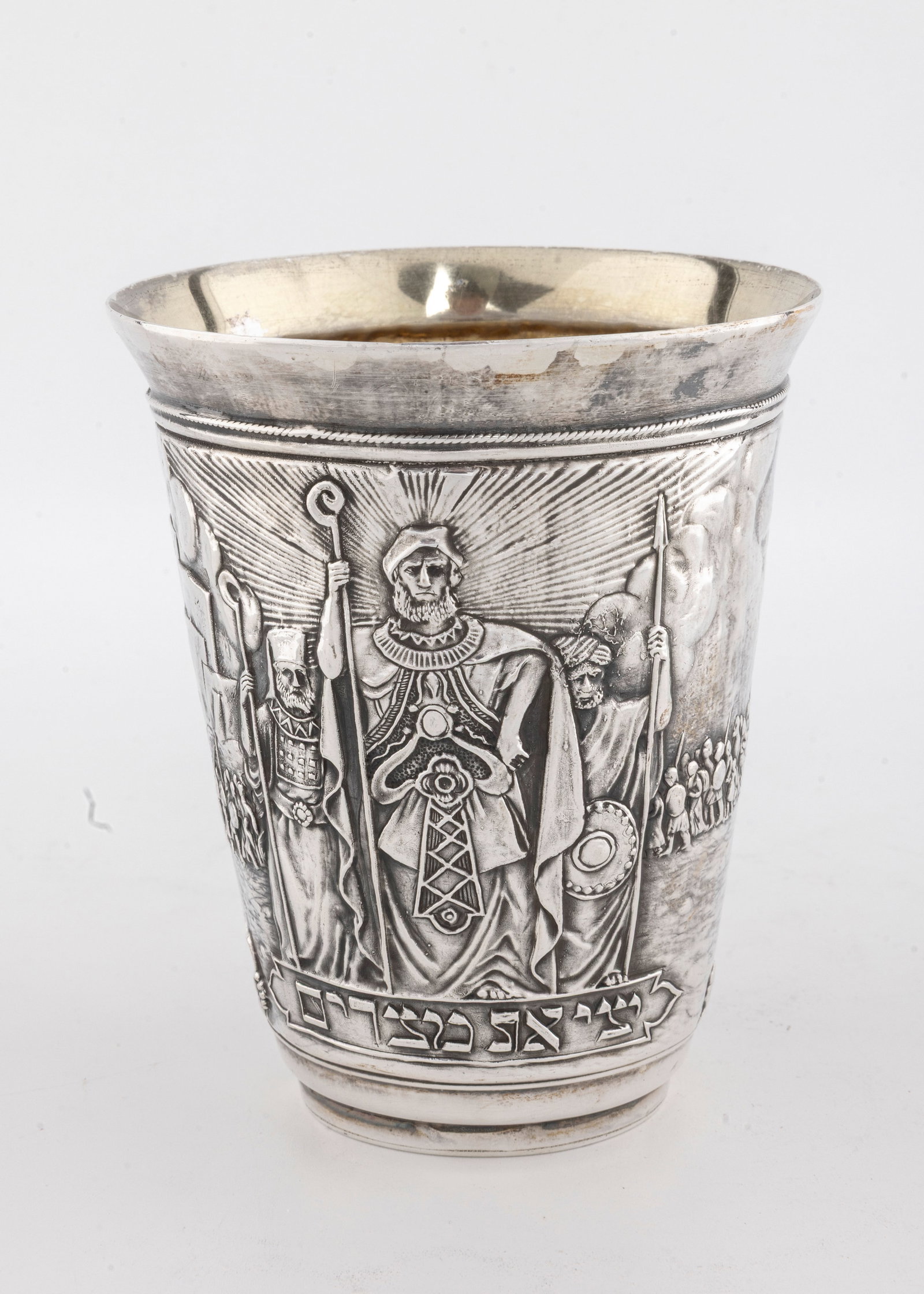 A STERLING SILVER PASSOVER CUP BY HENRYK WINOGRAD. New York, 1991.: Decorated with scenes of the Exodus and other Passover related designs. Signed. 