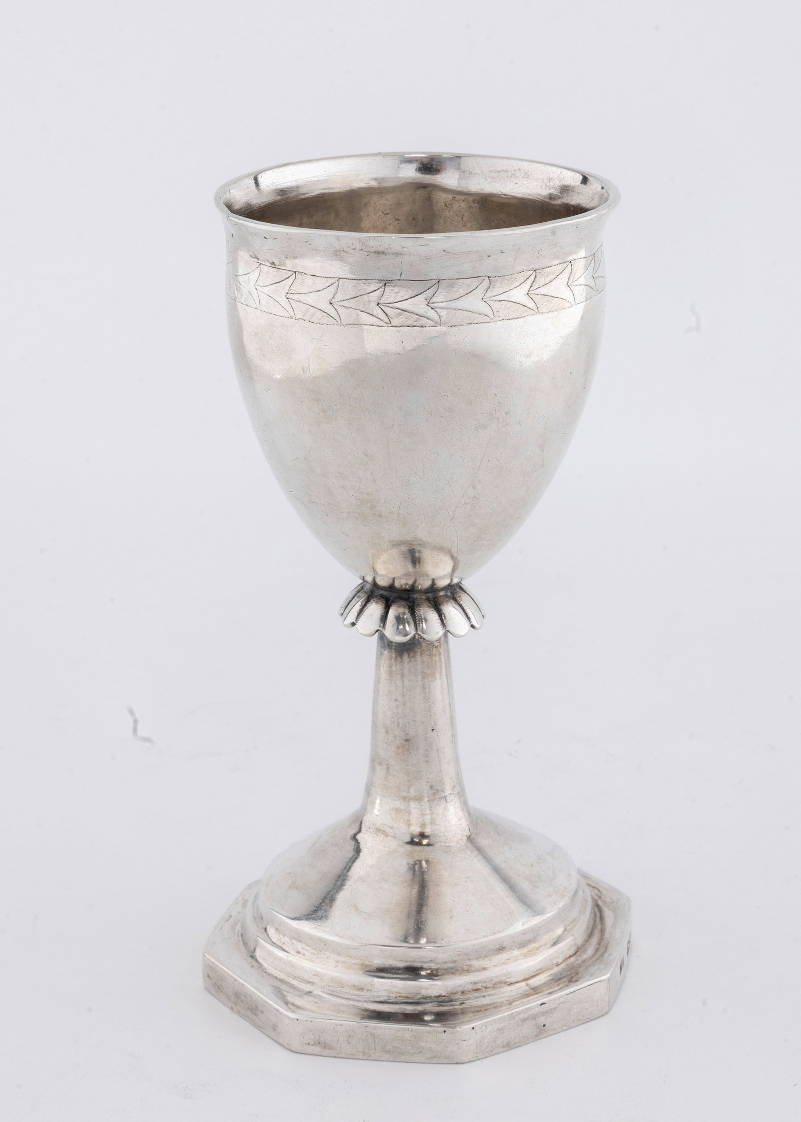 A LARGE SILVER KIDDUSH CUP. Poland, c. 1840: On an octagonal base with a skirted stem and an outwardly tapering wine section. Marked 12 and amakers mark of NS.